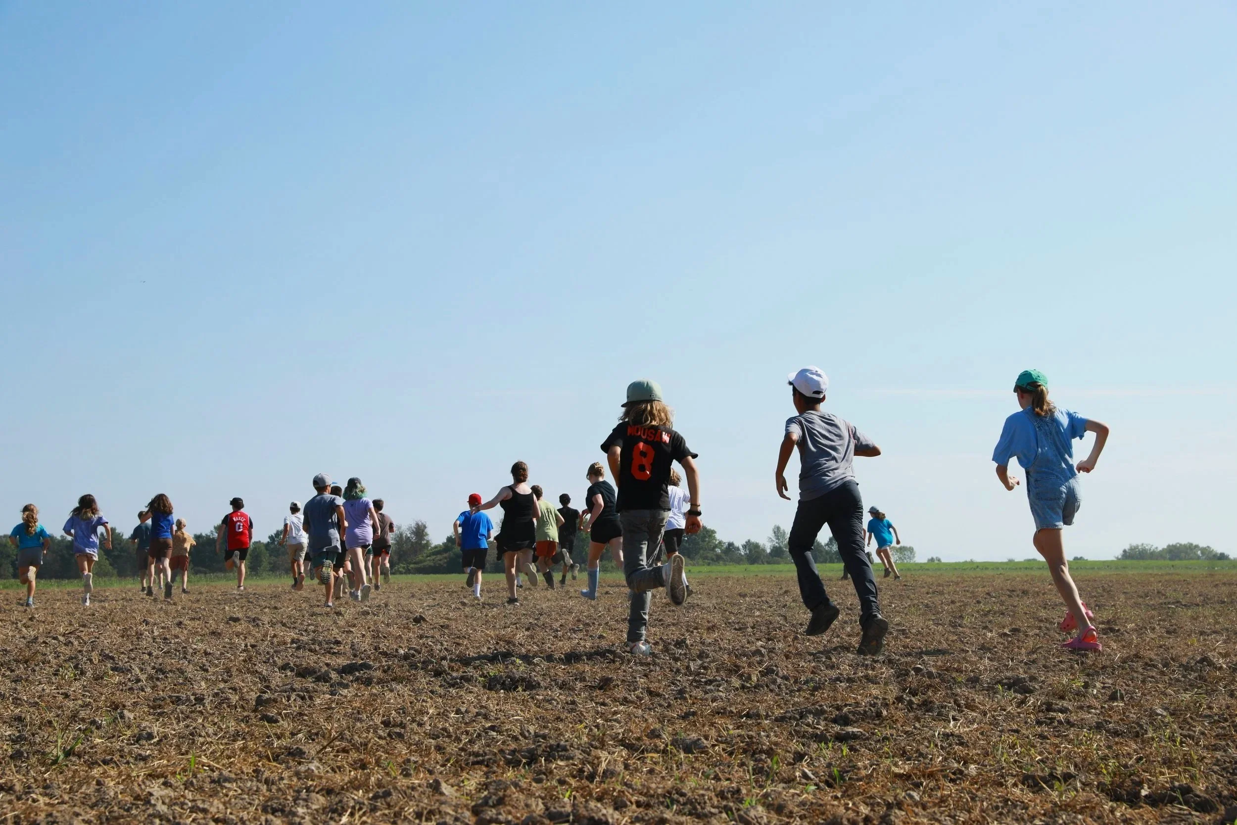Middle school students running on a farm