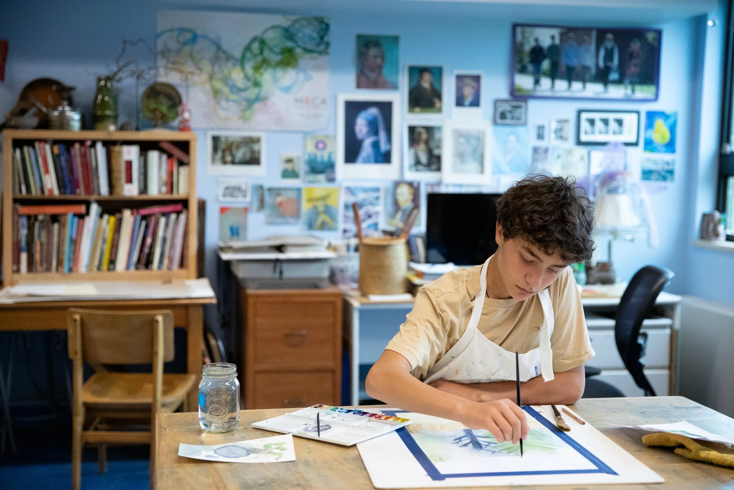 Boy painting in an art classroom