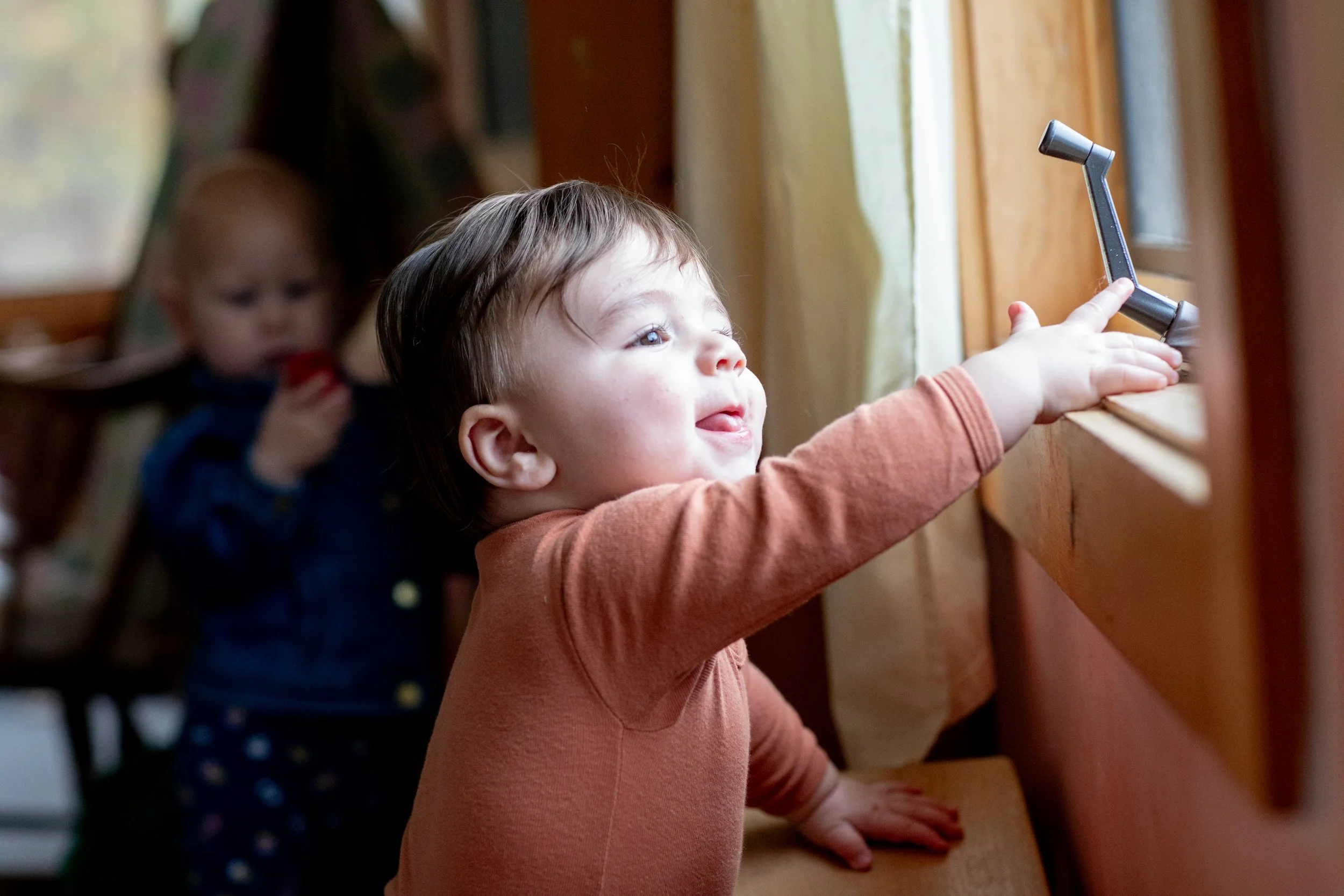 Toddler smiling in a classroom