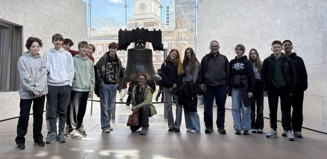 Teacher and students standing in front of the Liberty Bell