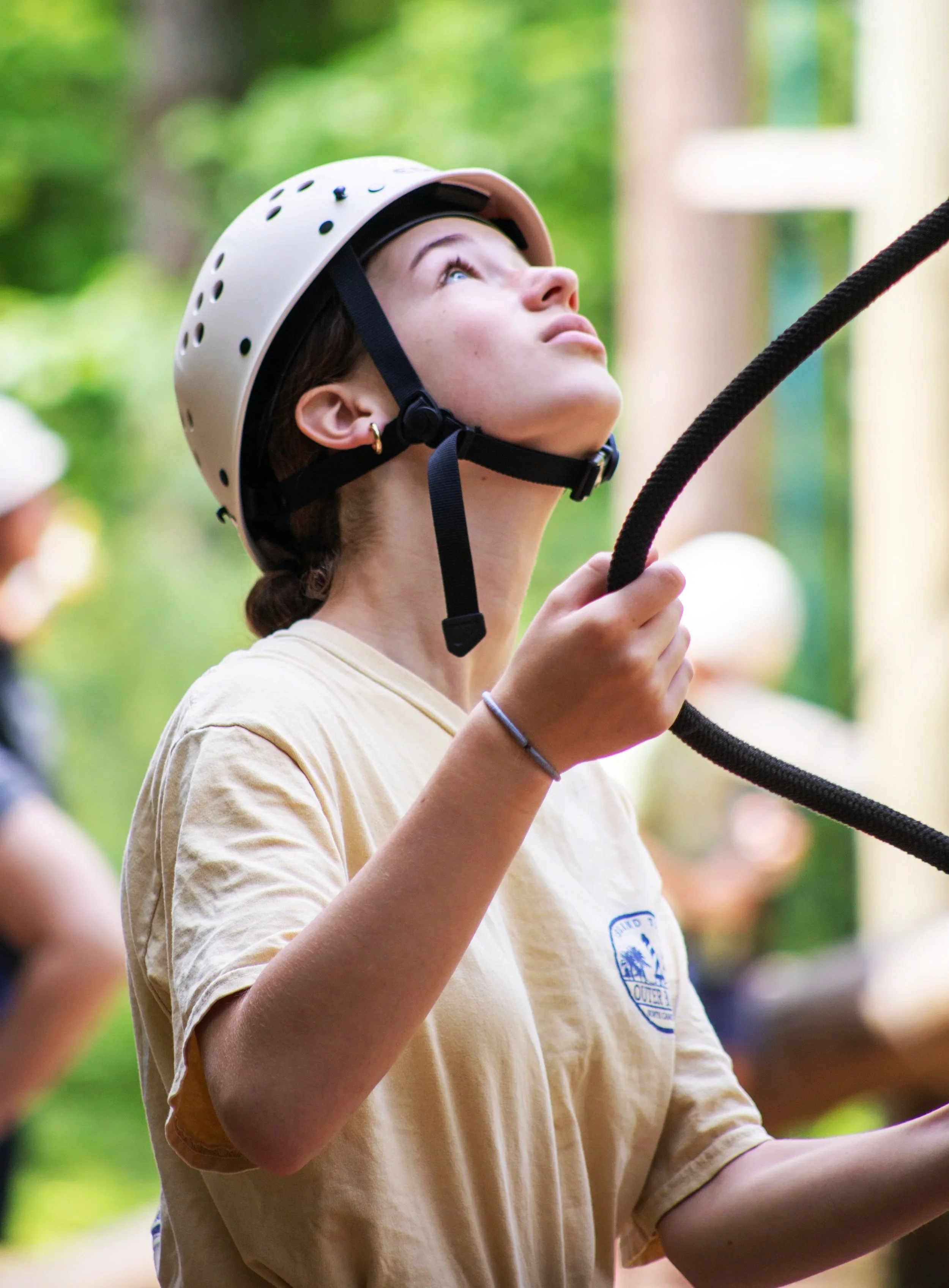 Girl rock climbing holding a belay line
