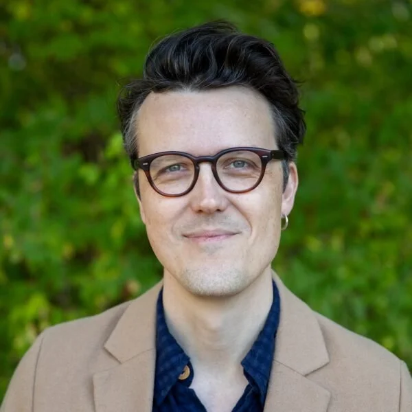 Person with glasses smiling