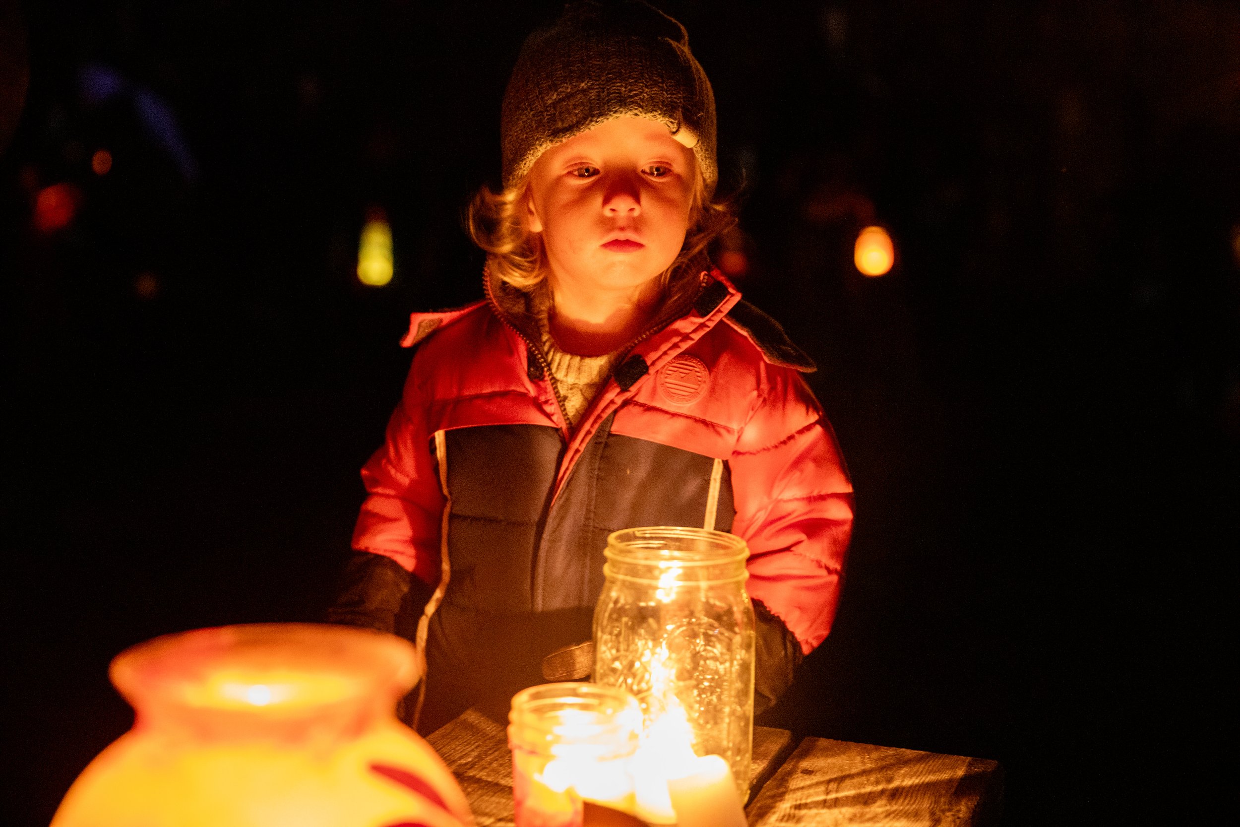 Early childhood student lit by lamplight at night