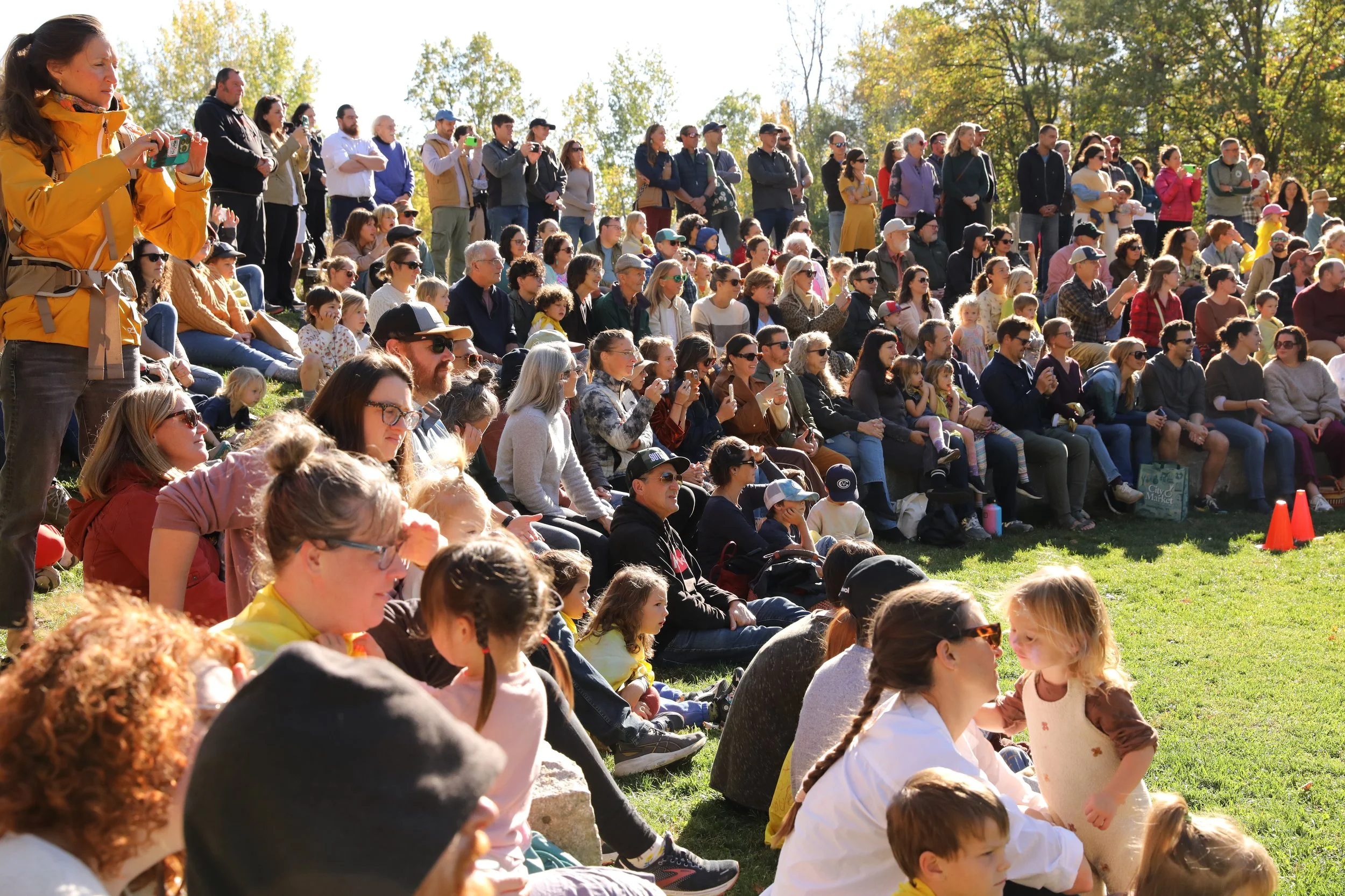 Large group of community members gather outside for a school event
