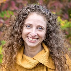 Woman with curly hair smiling