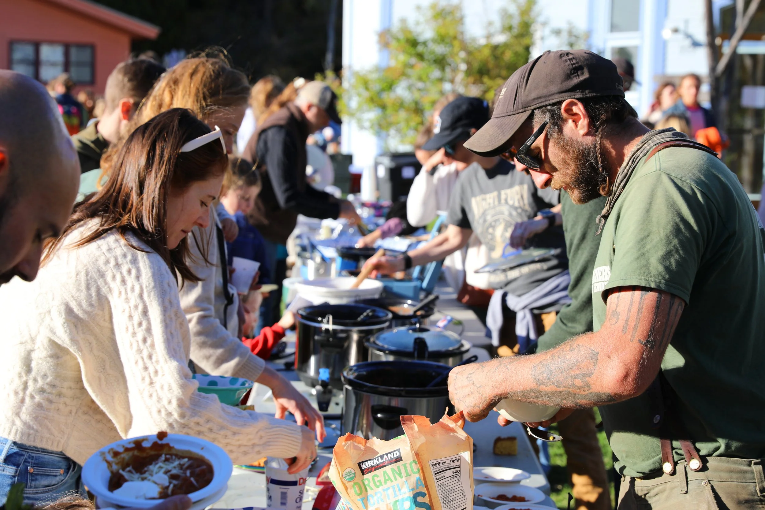Community members eating at an outdoor potluck
