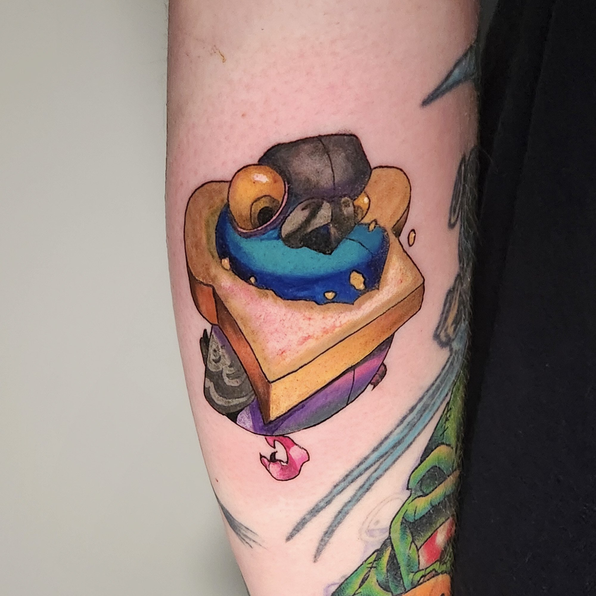 Colorful tattoo of a cartoon style pigeon