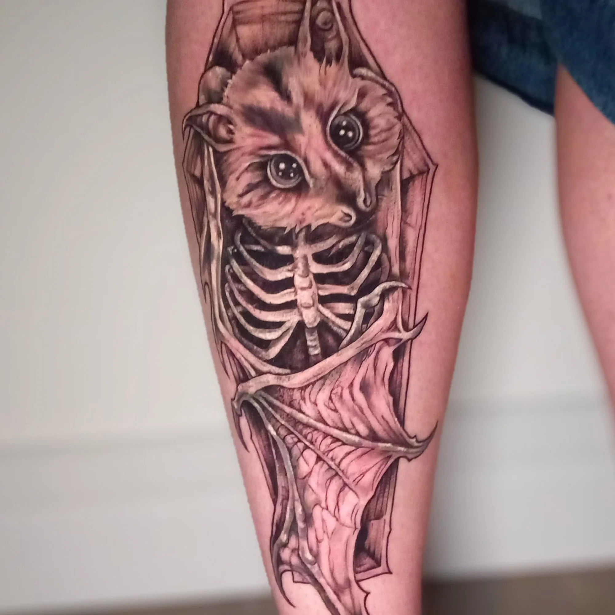 Tattoo of a cute puppy with big eyes on a person's arm