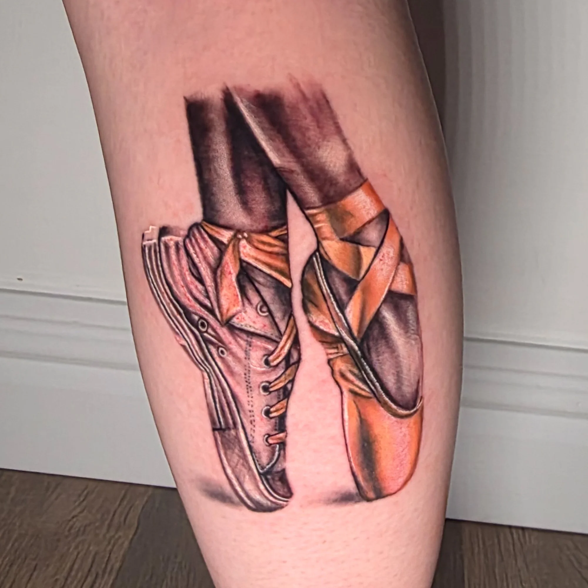 A tattoo of ballet shoes, one is a trainer