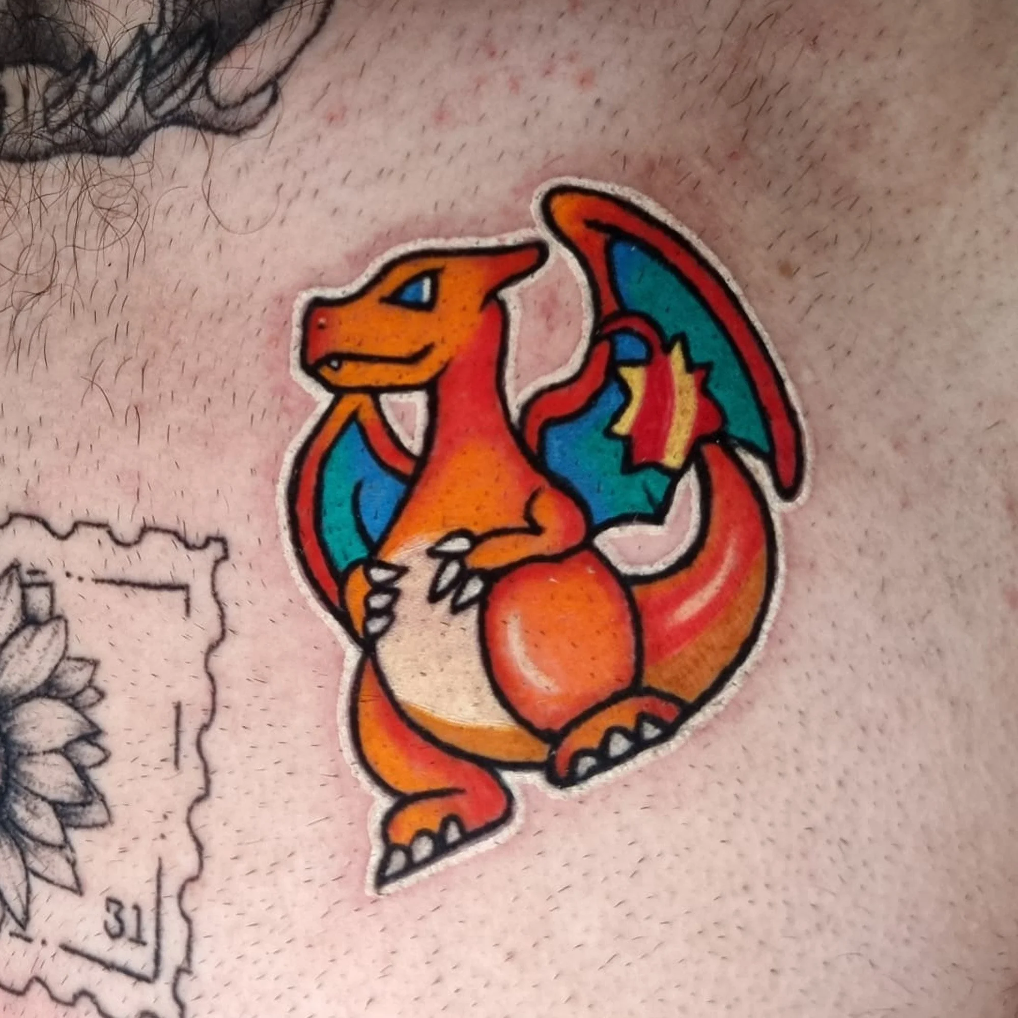 Close-up image of a colorful dragon on a person's skin.