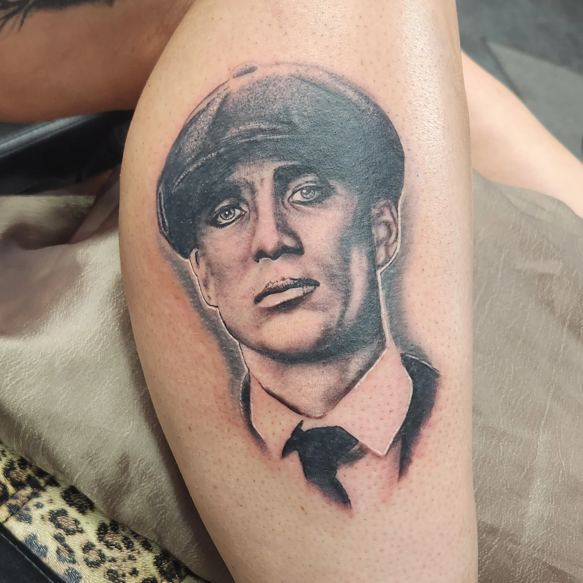 Black and grey portrait of Thomas Shelby in Peaky Blinders tattoo