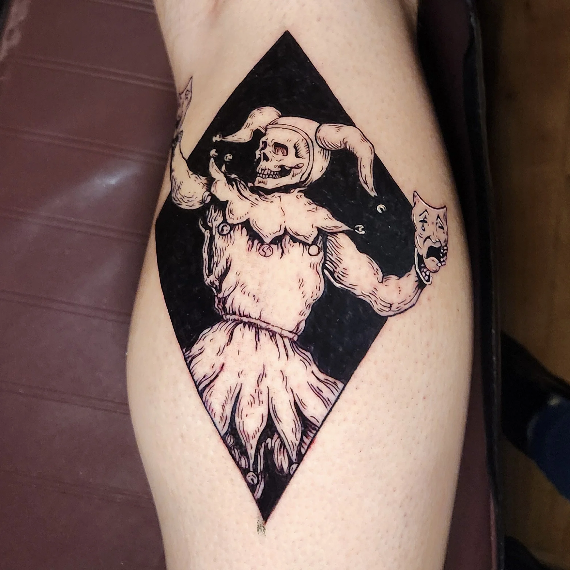 Black a grey tattoo of a jester