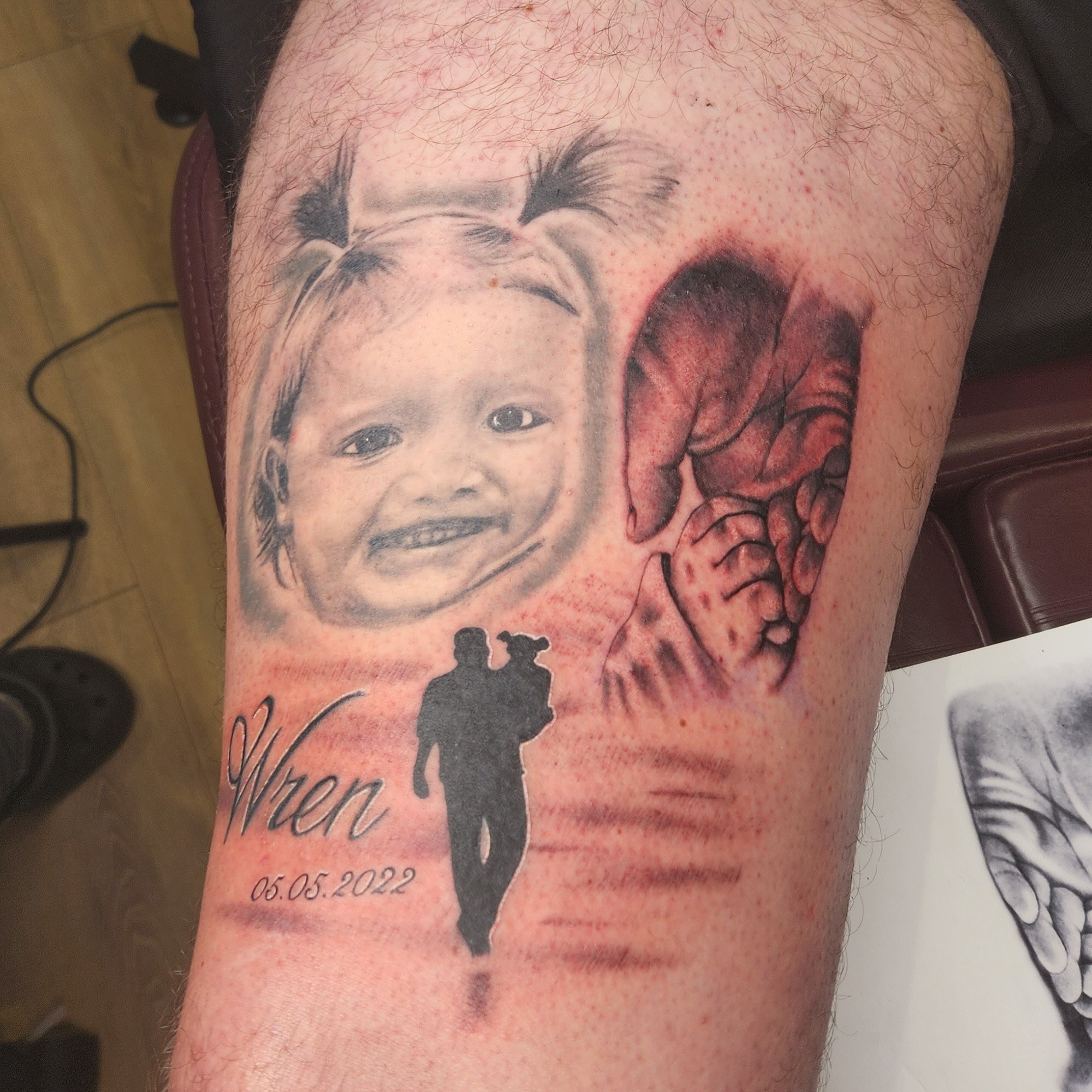 Realistic, black and grey portrait of young girl. Realistic hands and silhouette of father and daughter tattoo