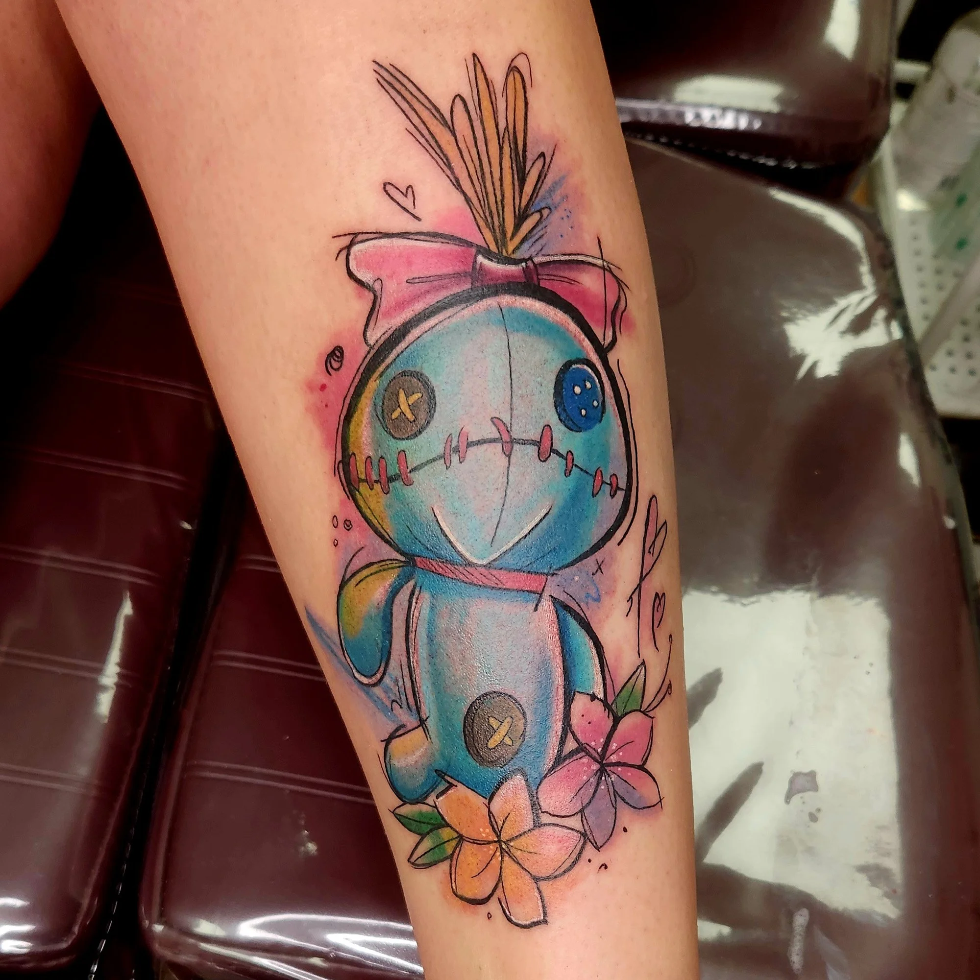 Colorful tattoo of a cloth doll