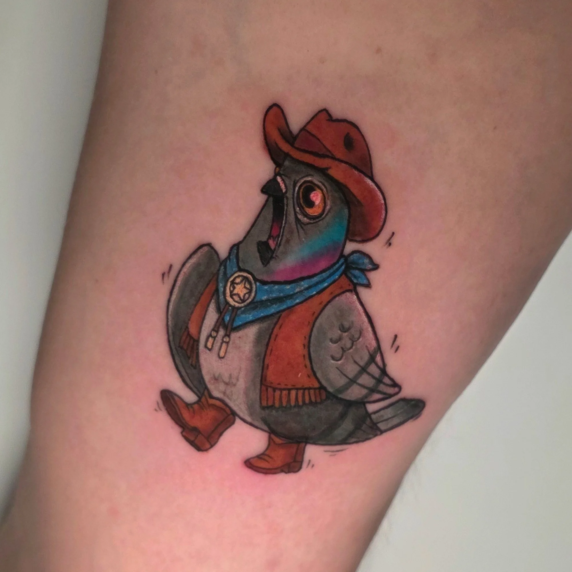 Colorful tattoo of a stylized scorpion on skin.