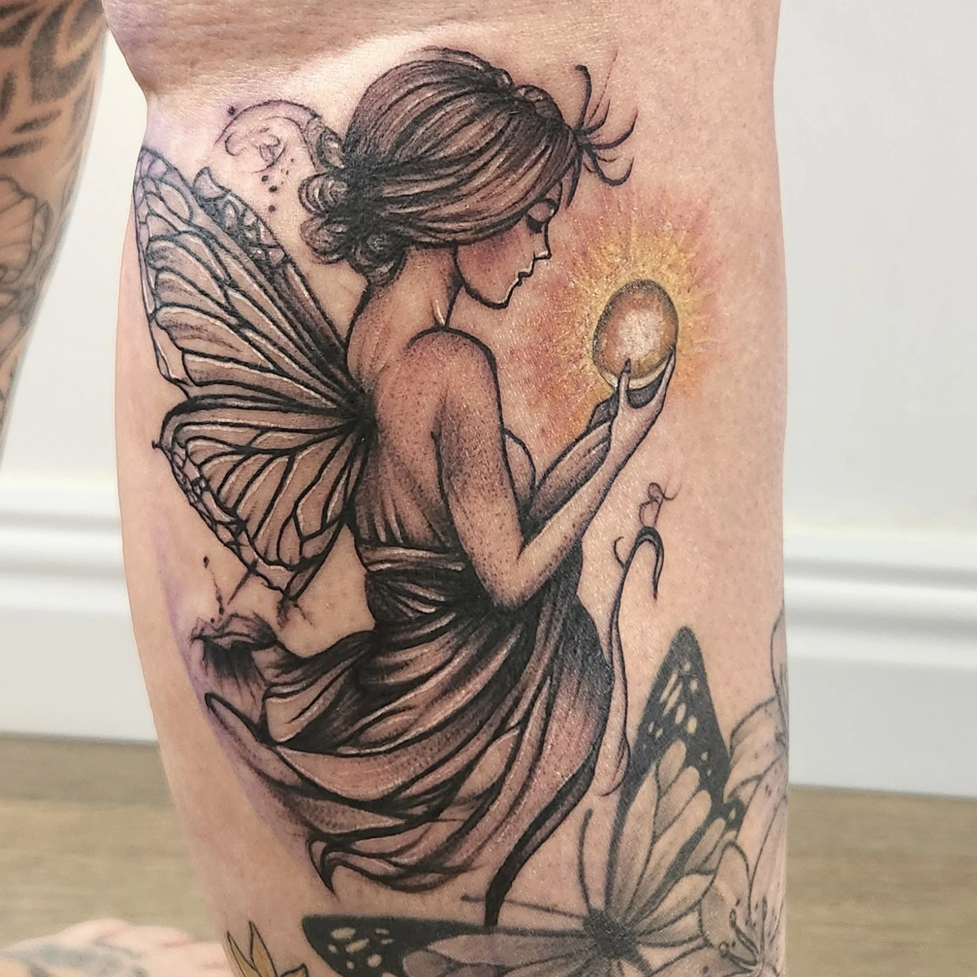 Fairy holding a orb tattoo