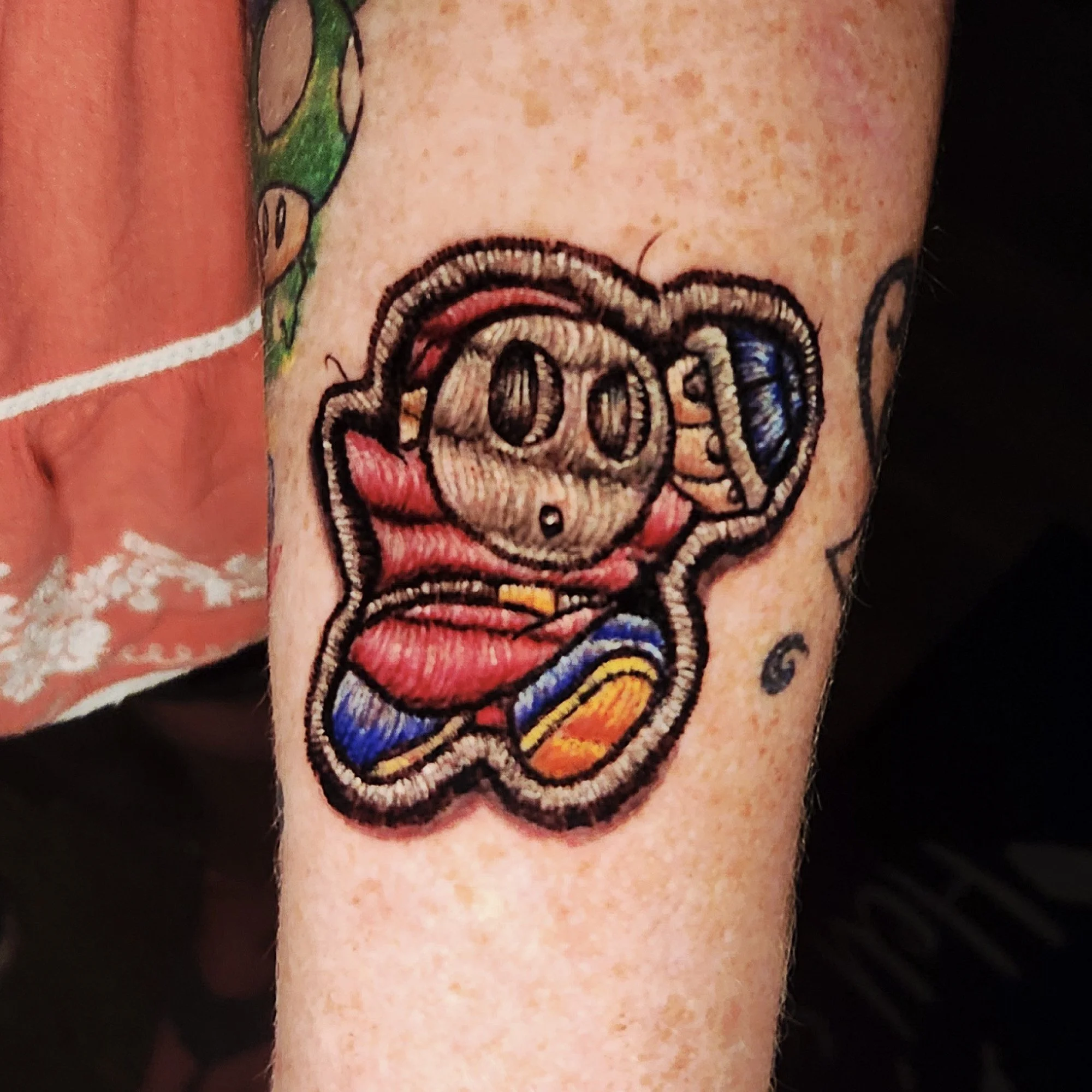 Colorful tattoo that looks like a sewn badge