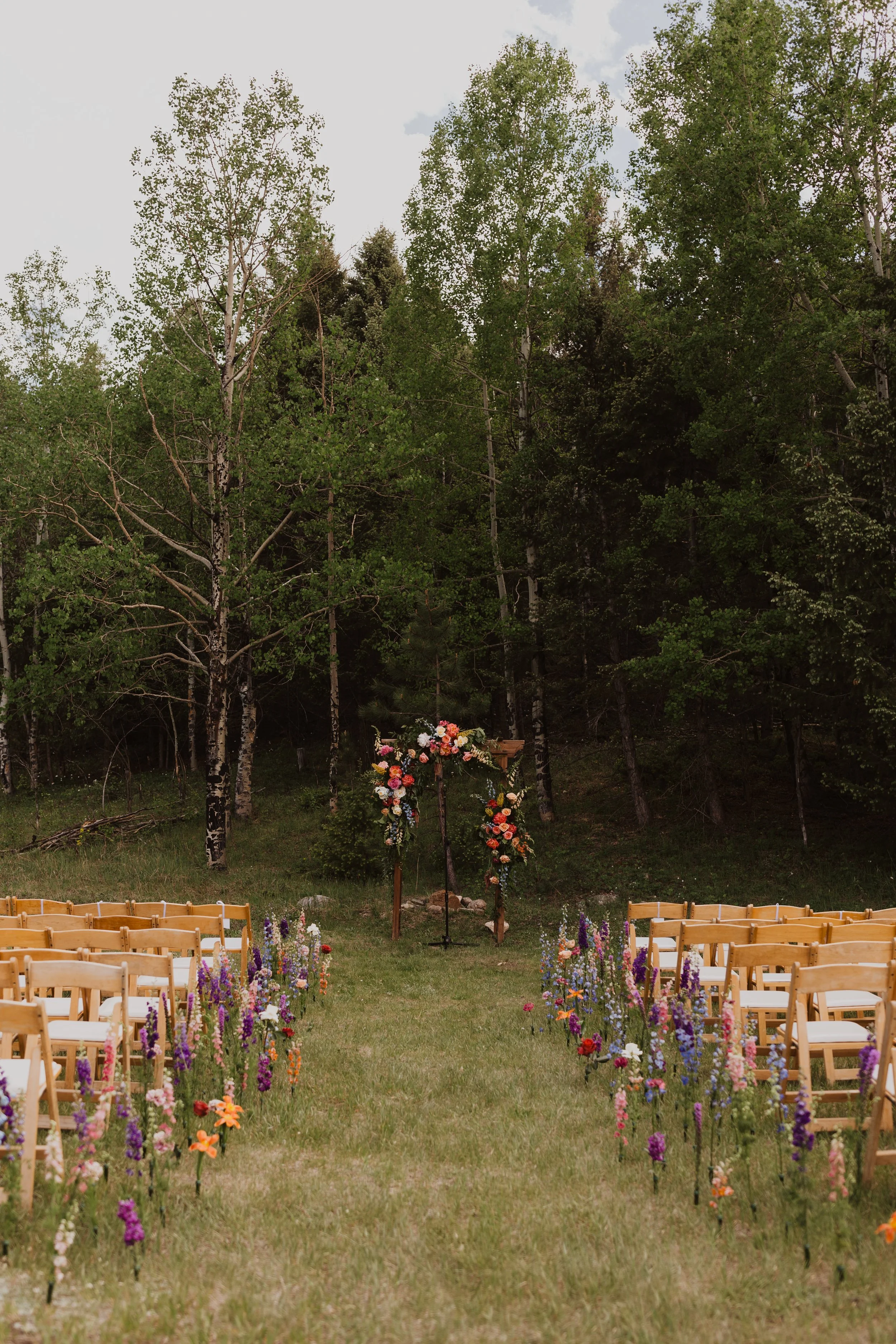 Outdoor wedding ceremony setup in meadow at Meadow Creek Lodge, a historic mountain wedding venue in Pine, Colorado near Denver.