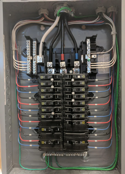 Electrical breaker panel with circuit breakers and wiring.