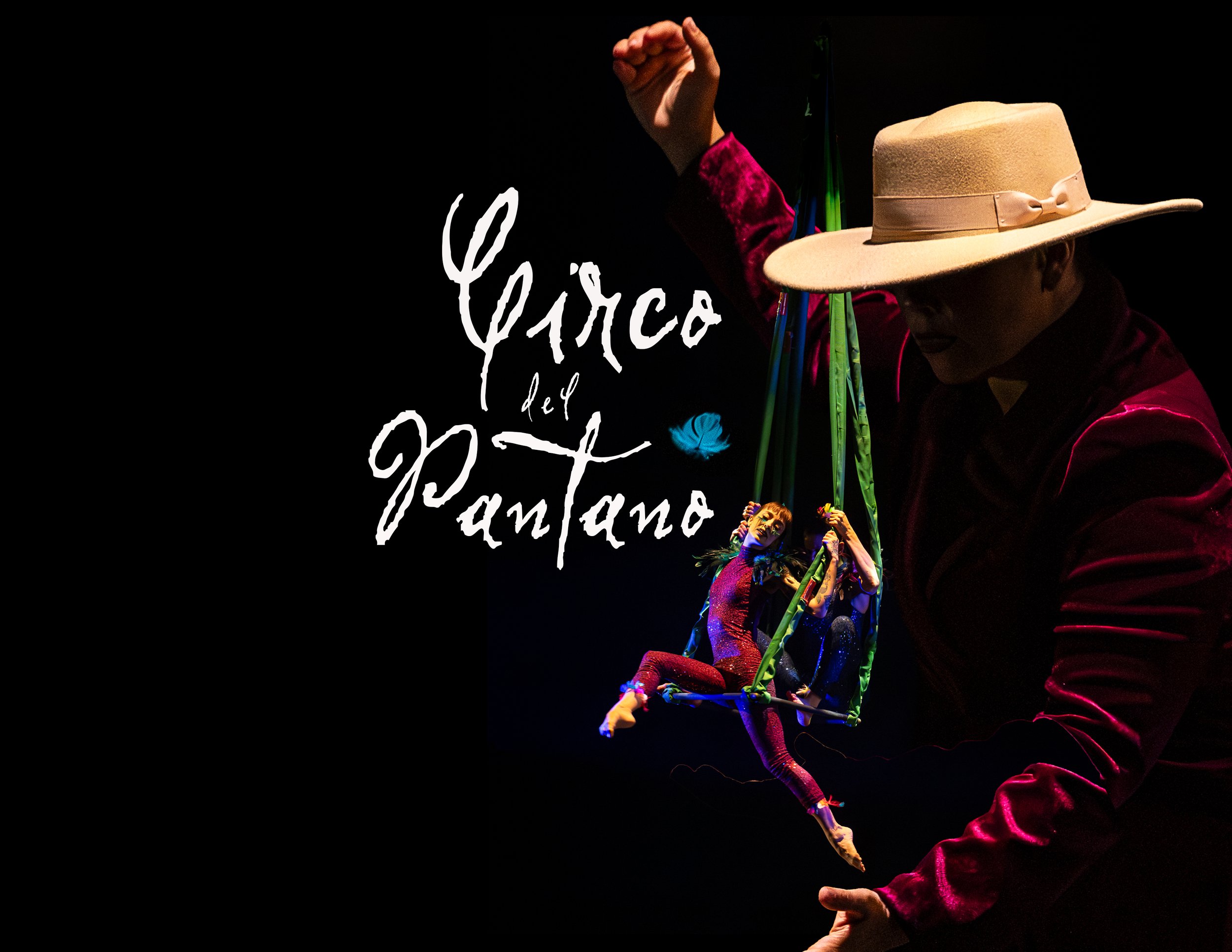 Performer in a red velvet costume and a beige wide-brimmed hat performing a circus act using a green trapeze, with a dark background and a person assisting or supporting from the side.