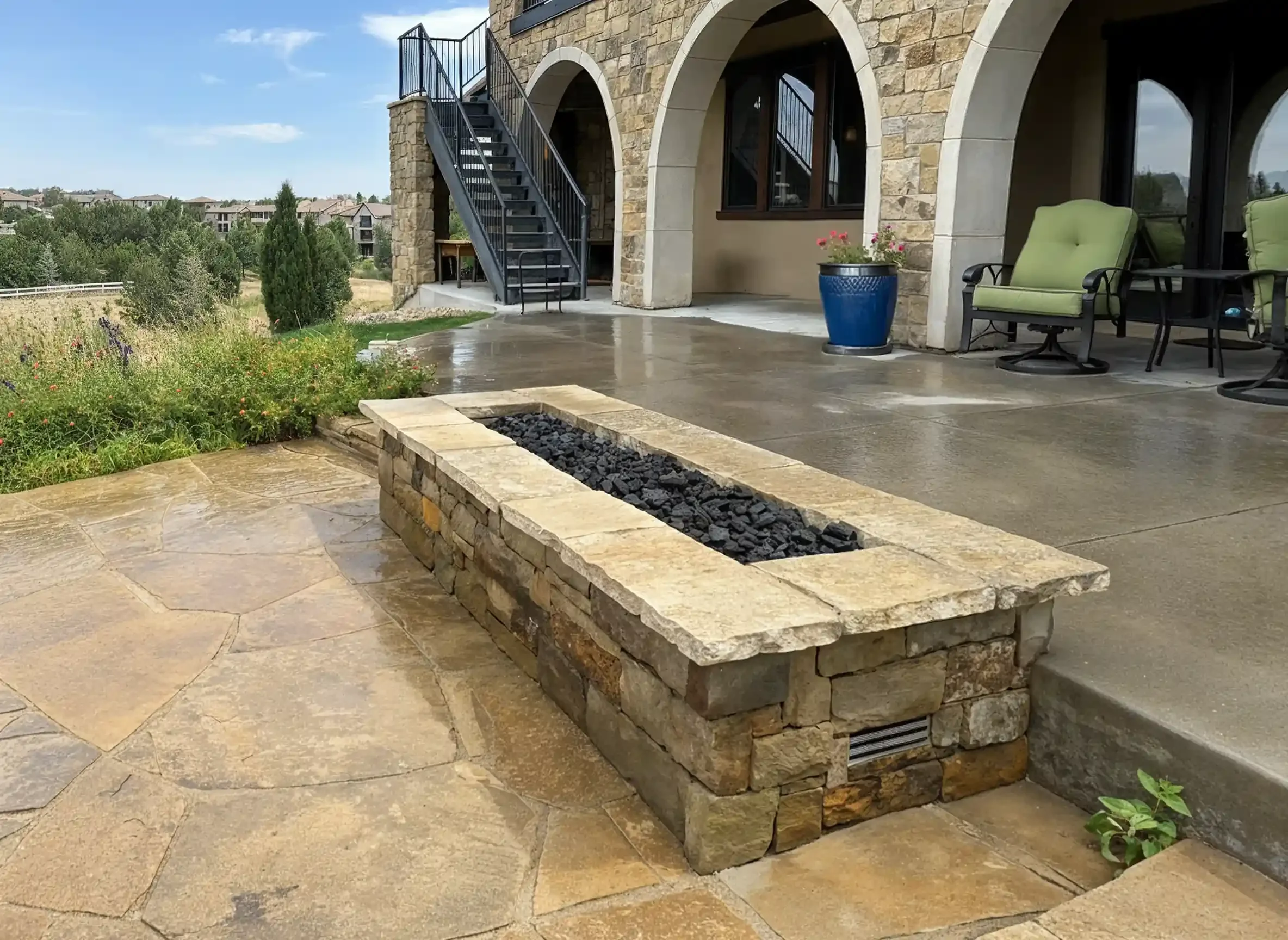 modern-stone-patio-rectangular-gas-firepit-outdoor-living-space.webp