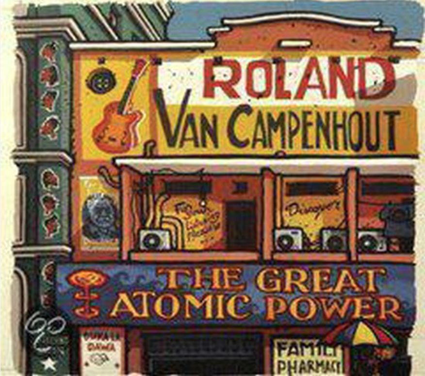 Colorful street art sign featuring the name 'Roland Van Campenhout' with a guitar and speaker illustration, text 'The Great Atomic Power,' and various smaller signs for a family pharmacy and other establishments.