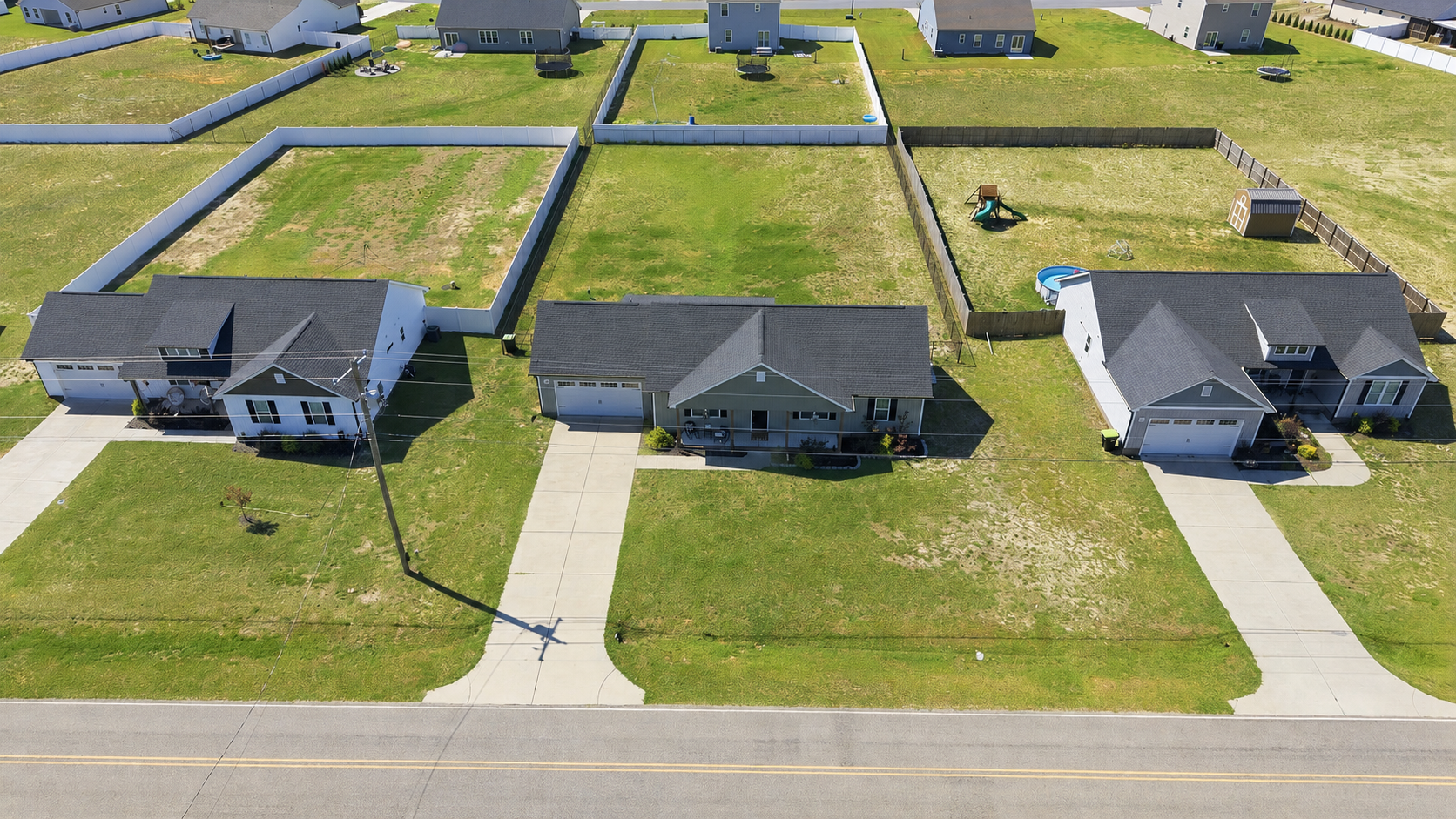 Aerial view of newer single-family homes with large yards in a Bailey, North Carolina neighborhood.
