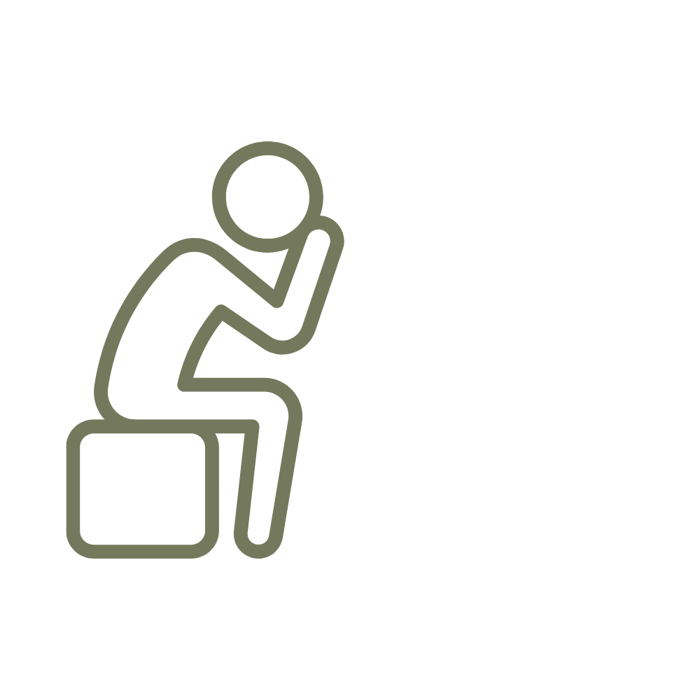 Person sitting on a bench, holding their head in their hand, depicting sadness or distress.