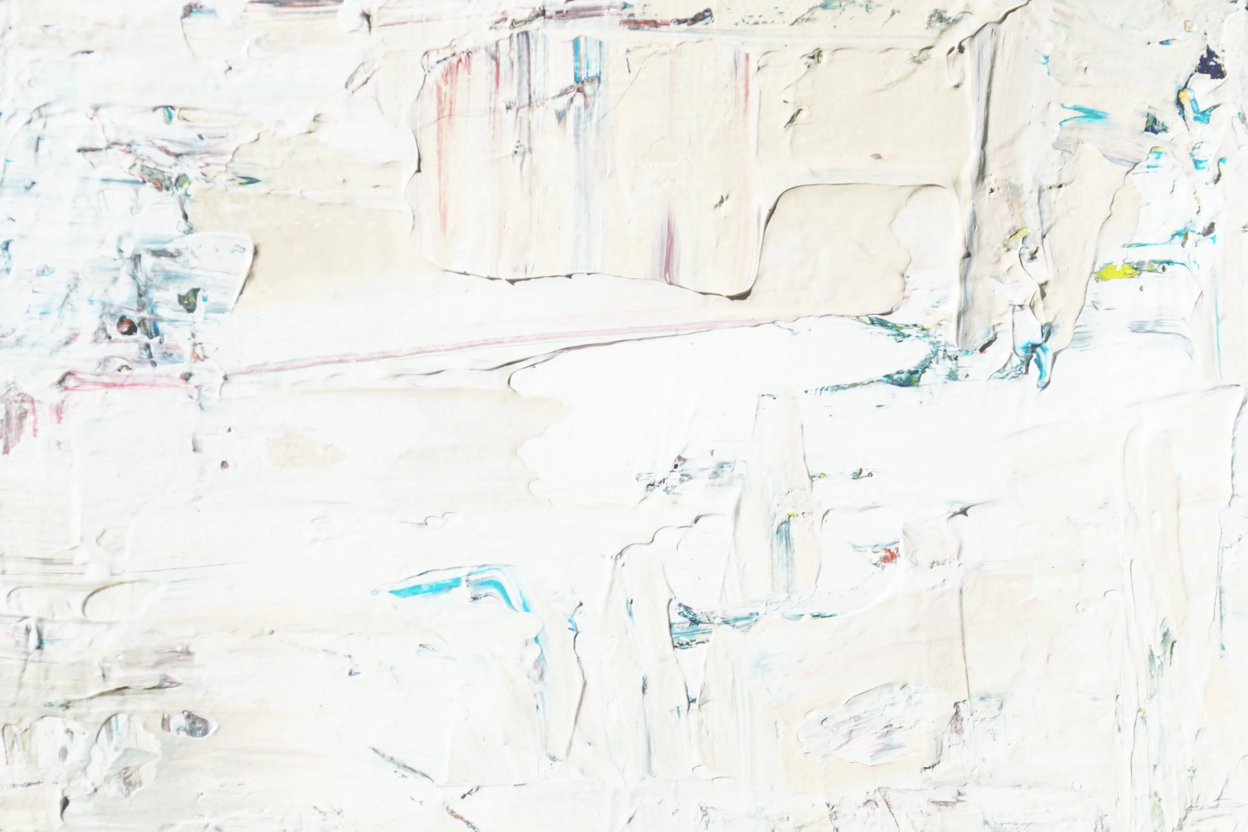 Abstract painting with broad, textured brushstrokes predominantly in white, with hints of blue, red, yellow, and green.