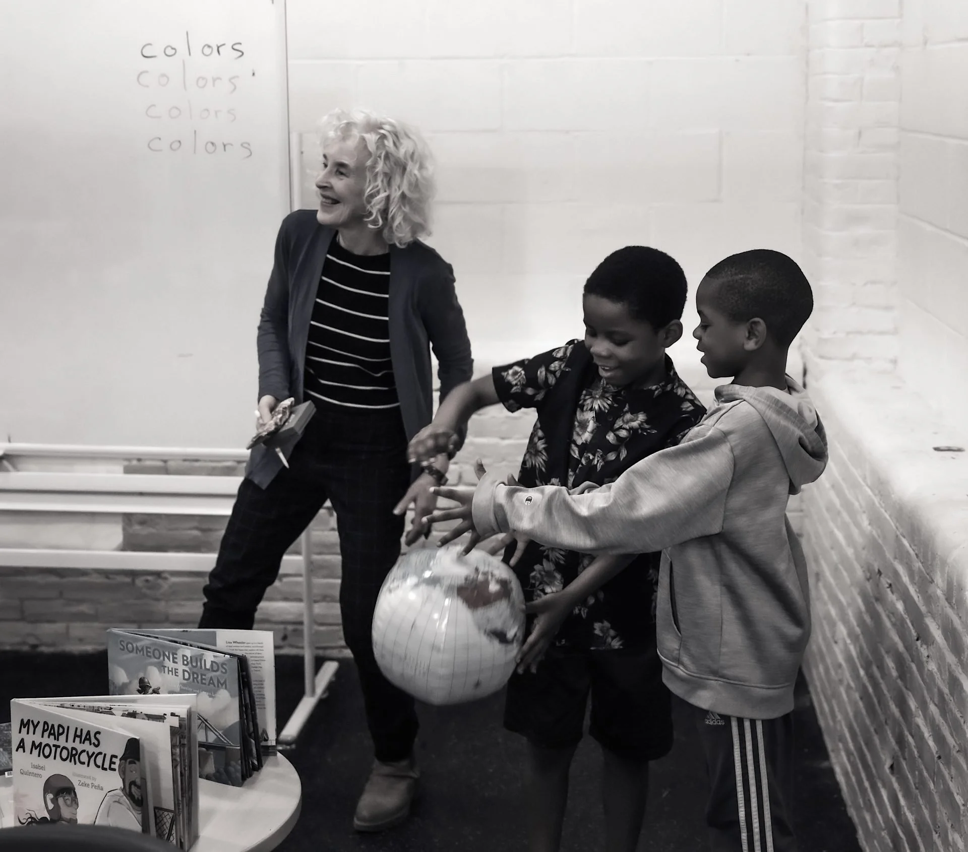 Terry Farish and boys in classroom with globe