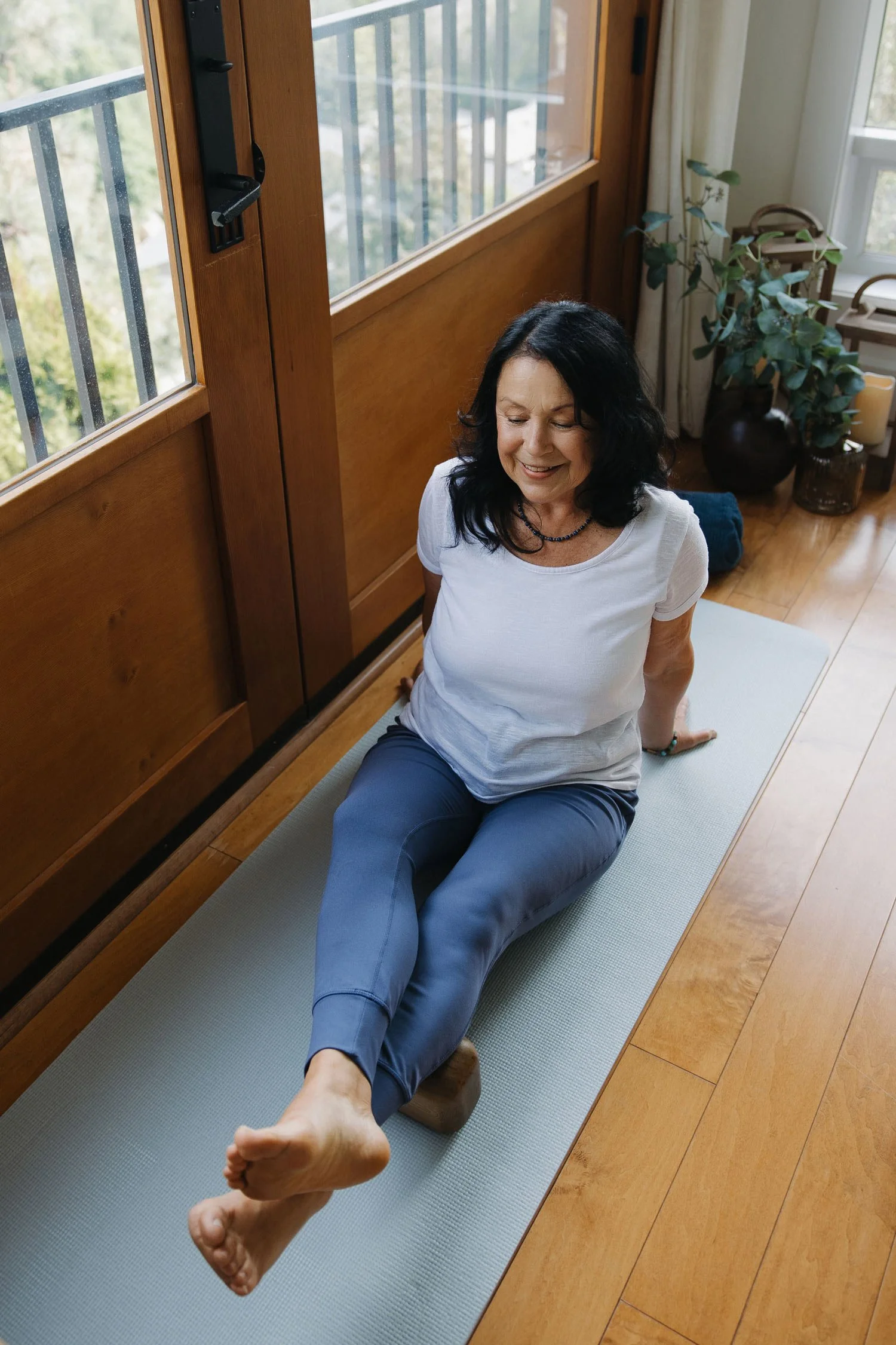 Woman practicing Block Therapy on a yoga mat during a fascia release class in Summerland, BC