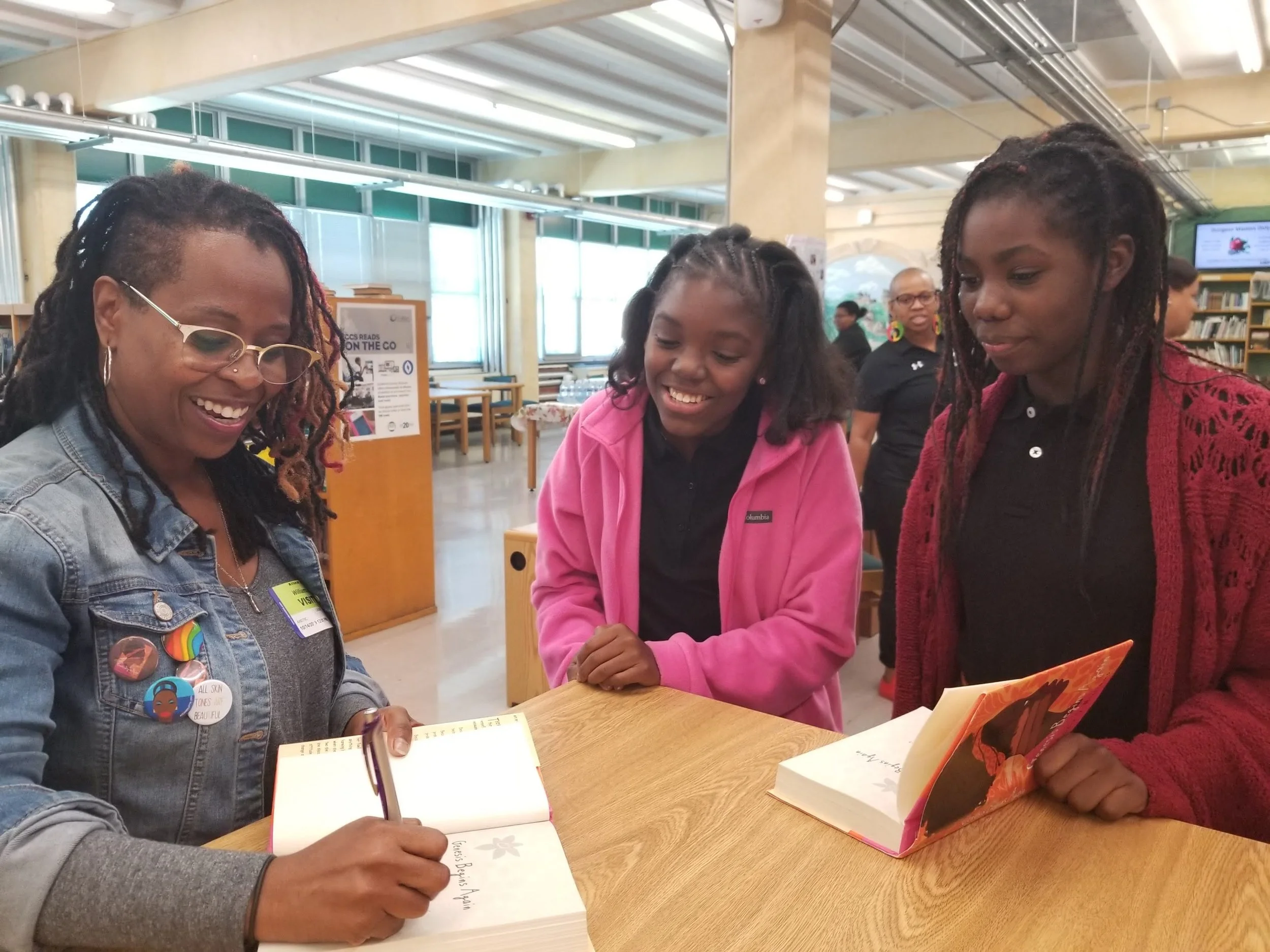 Two African American children chatting with an African American Adult