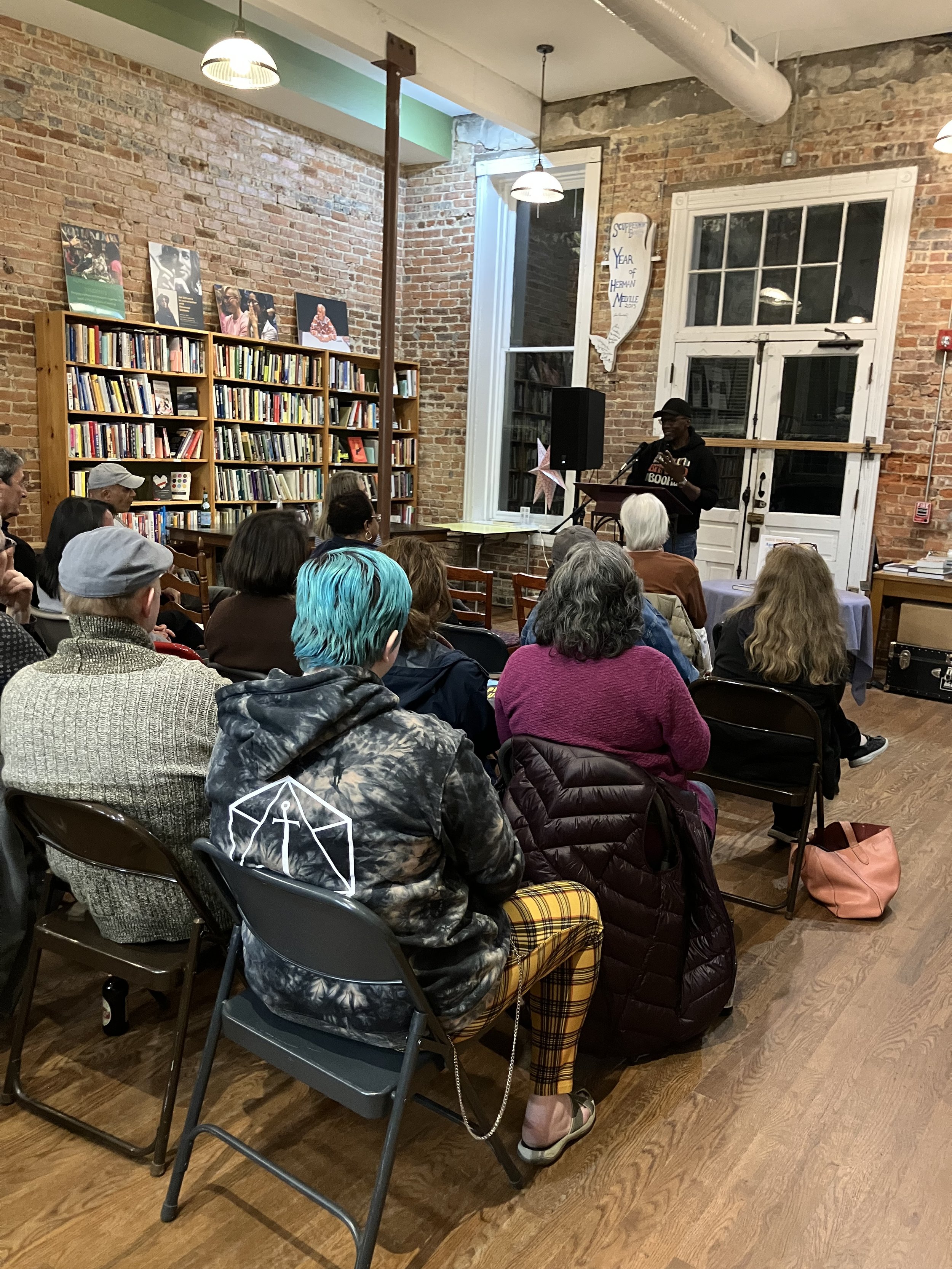 A crowd of folks listening to a speaker