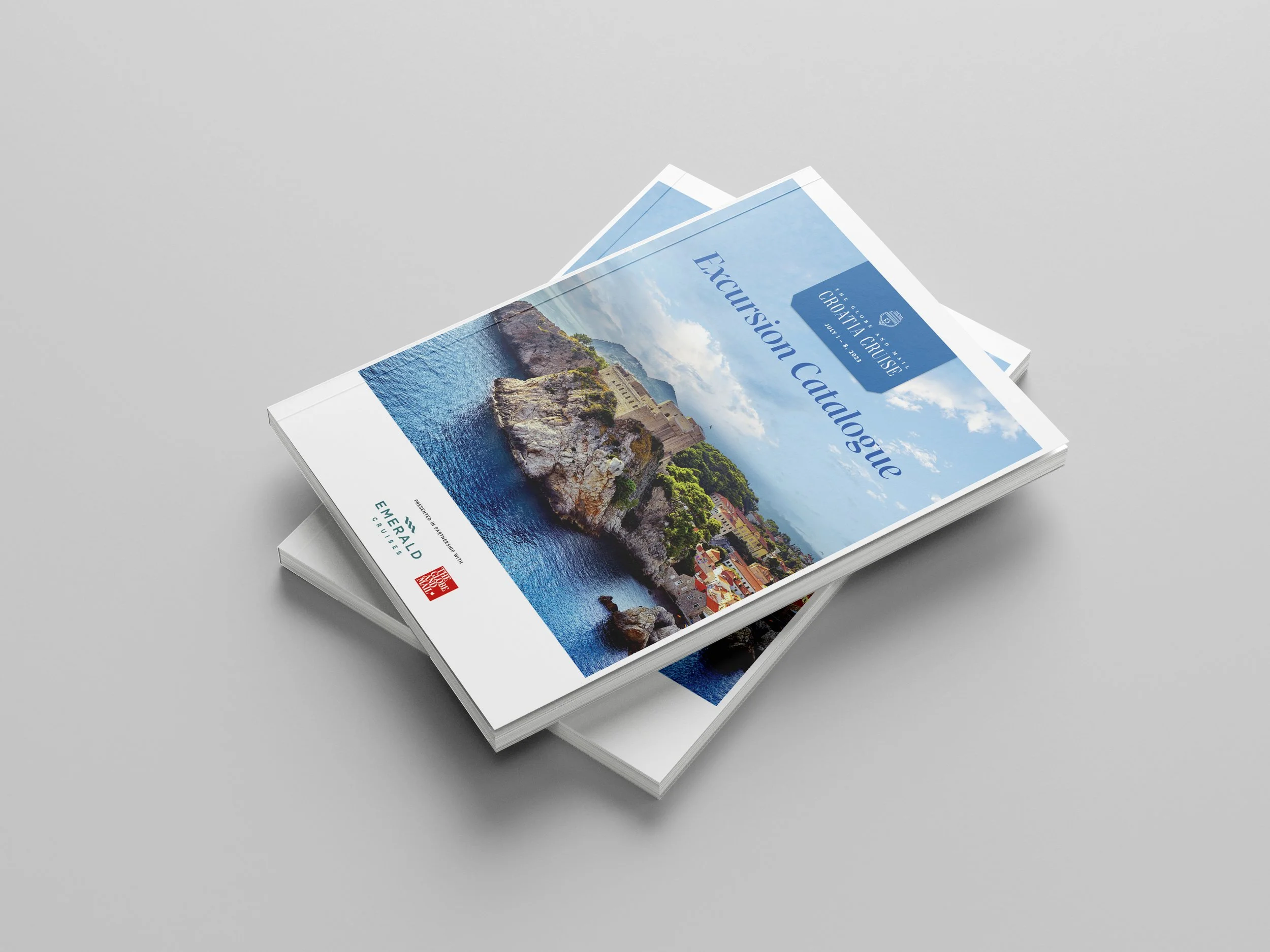 Travel brochure titled 'Exursion Catalogue' with a landscape photo of a coastal fortress, mountains, and blue sky on a grey background.