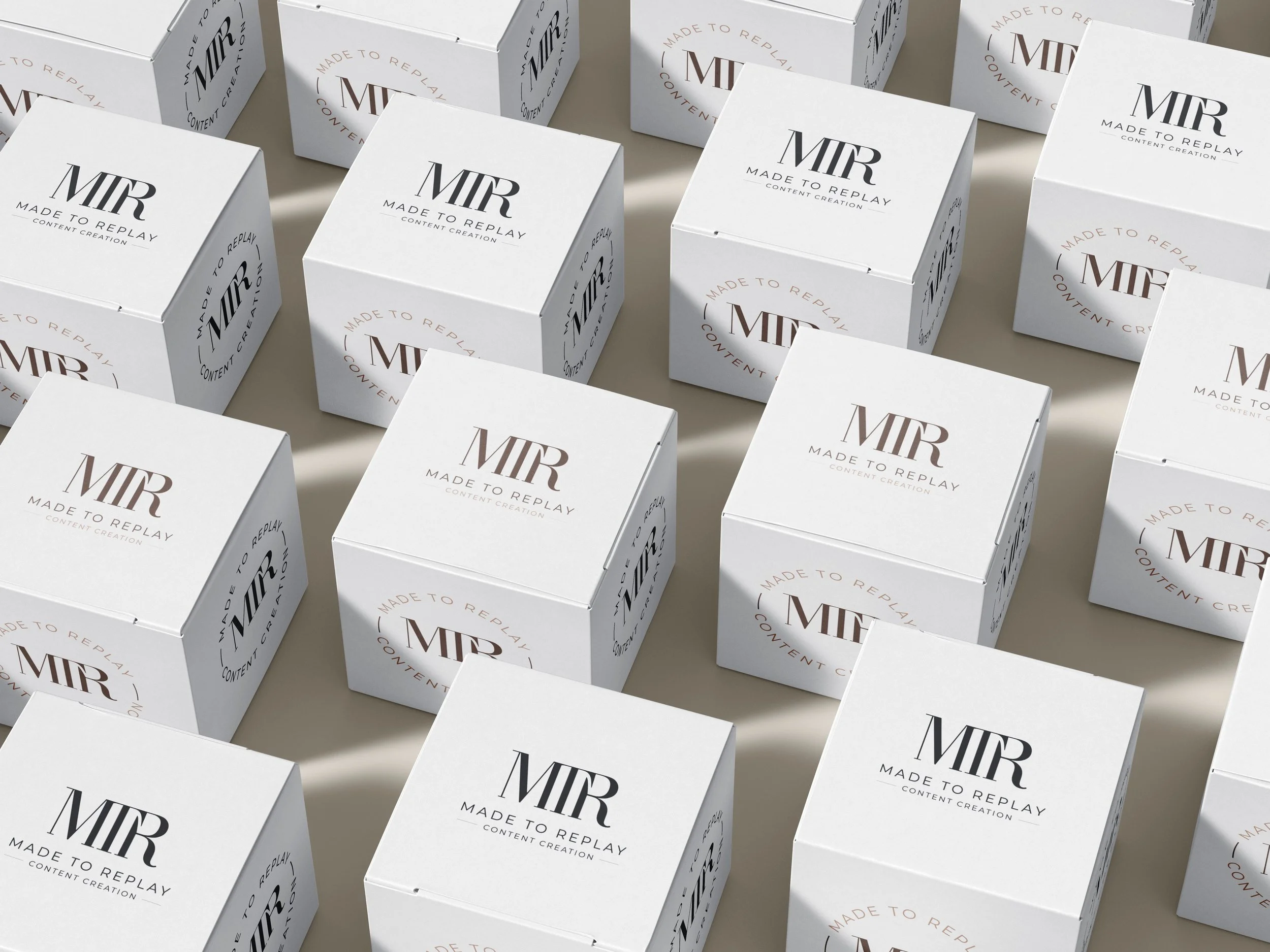 Multiple white boxes with the word 'MTR' and the phrase 'Made to Replay Content Creation' printed on them, arranged in a pattern.