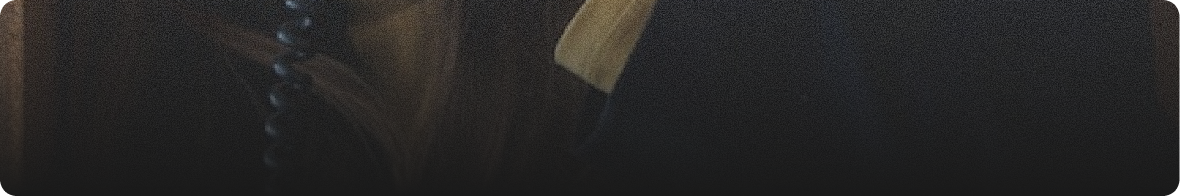 A dark image with a faint, partially visible object, possibly a book or a similar item, in low lighting.