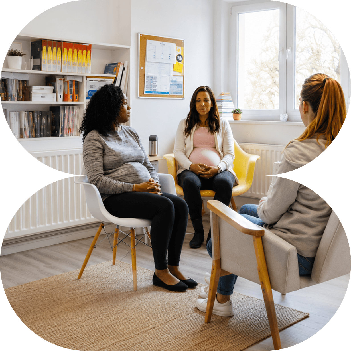 A pregnant woman and two women are having a counseling session in a bright room with shelves, a window, and a corkboard.