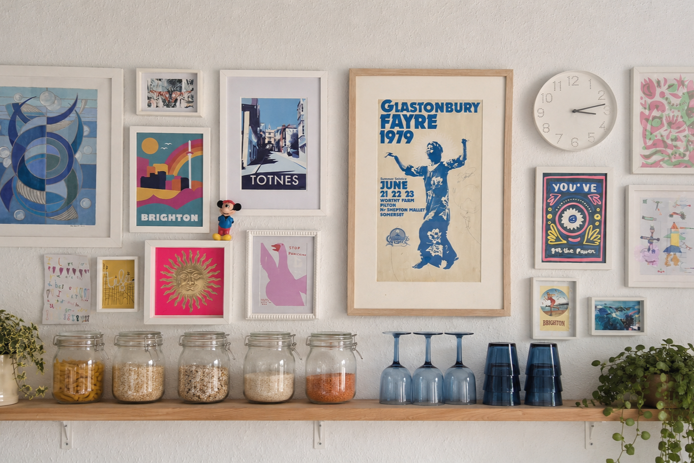 Gallery wall and styled shelving creating personality and visual interest.