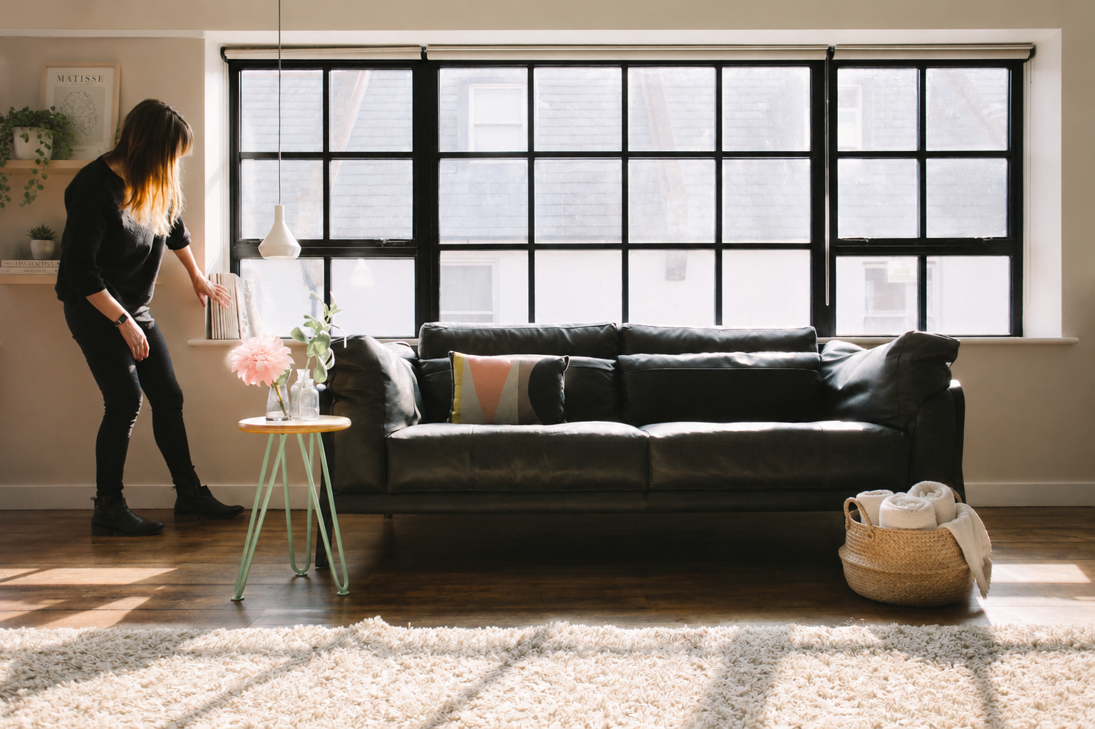 Interior stylist preparing a living space to help clients settle into their new home after moving.