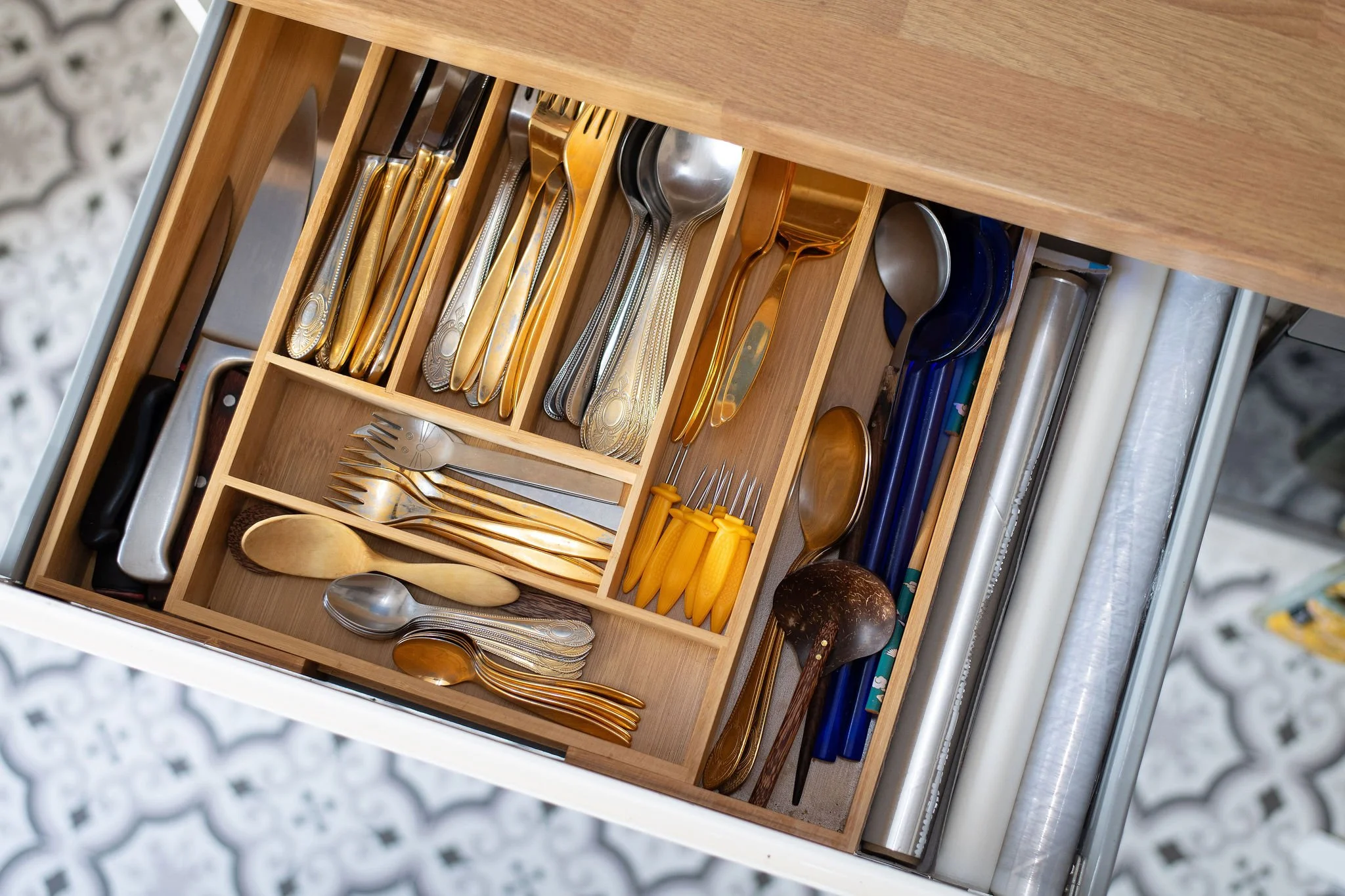 Professionally organised kitchen drawer with practical storage solutions for everyday use.