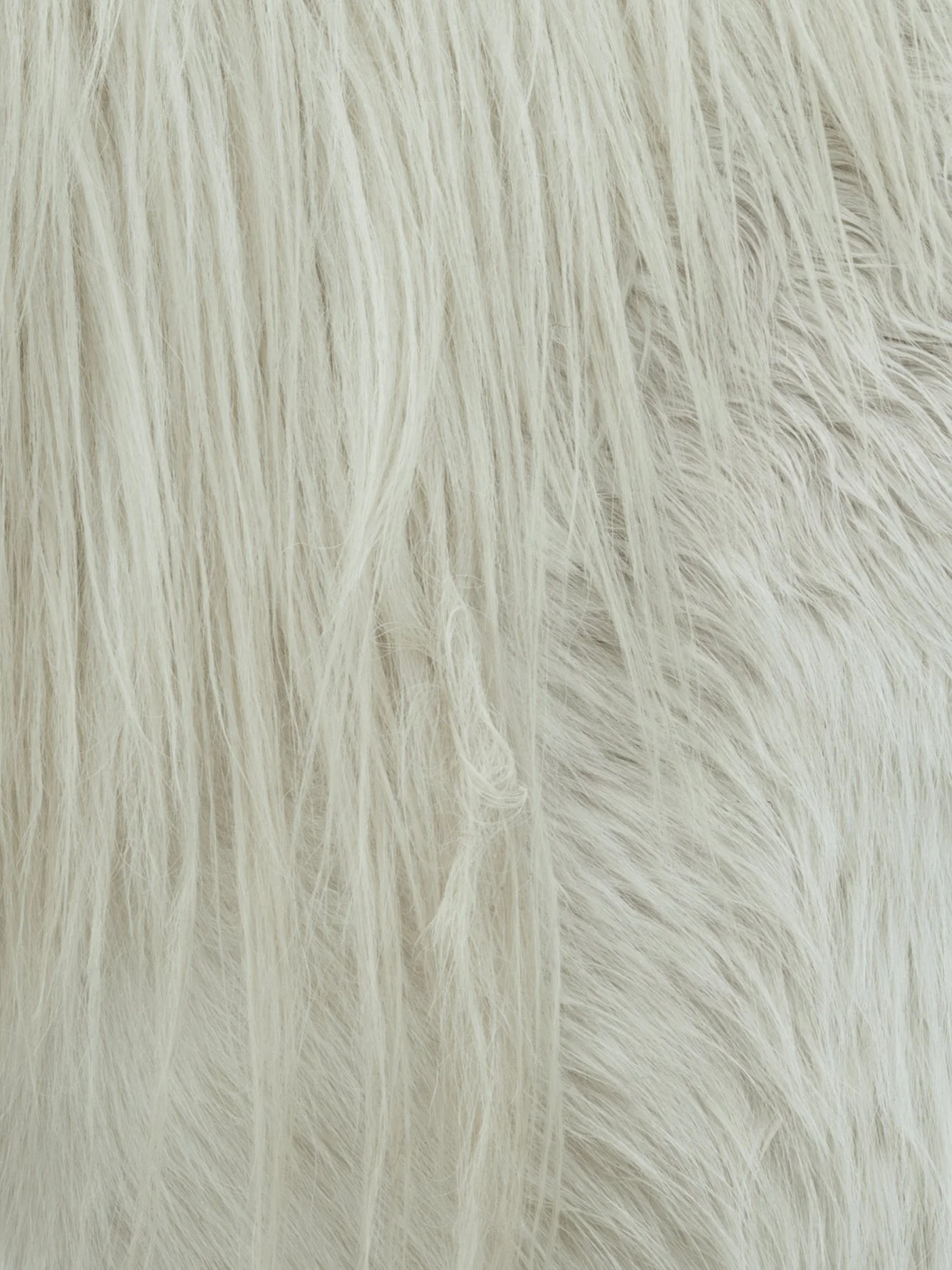Close-up of white/fawn fur with long, soft hairs.
