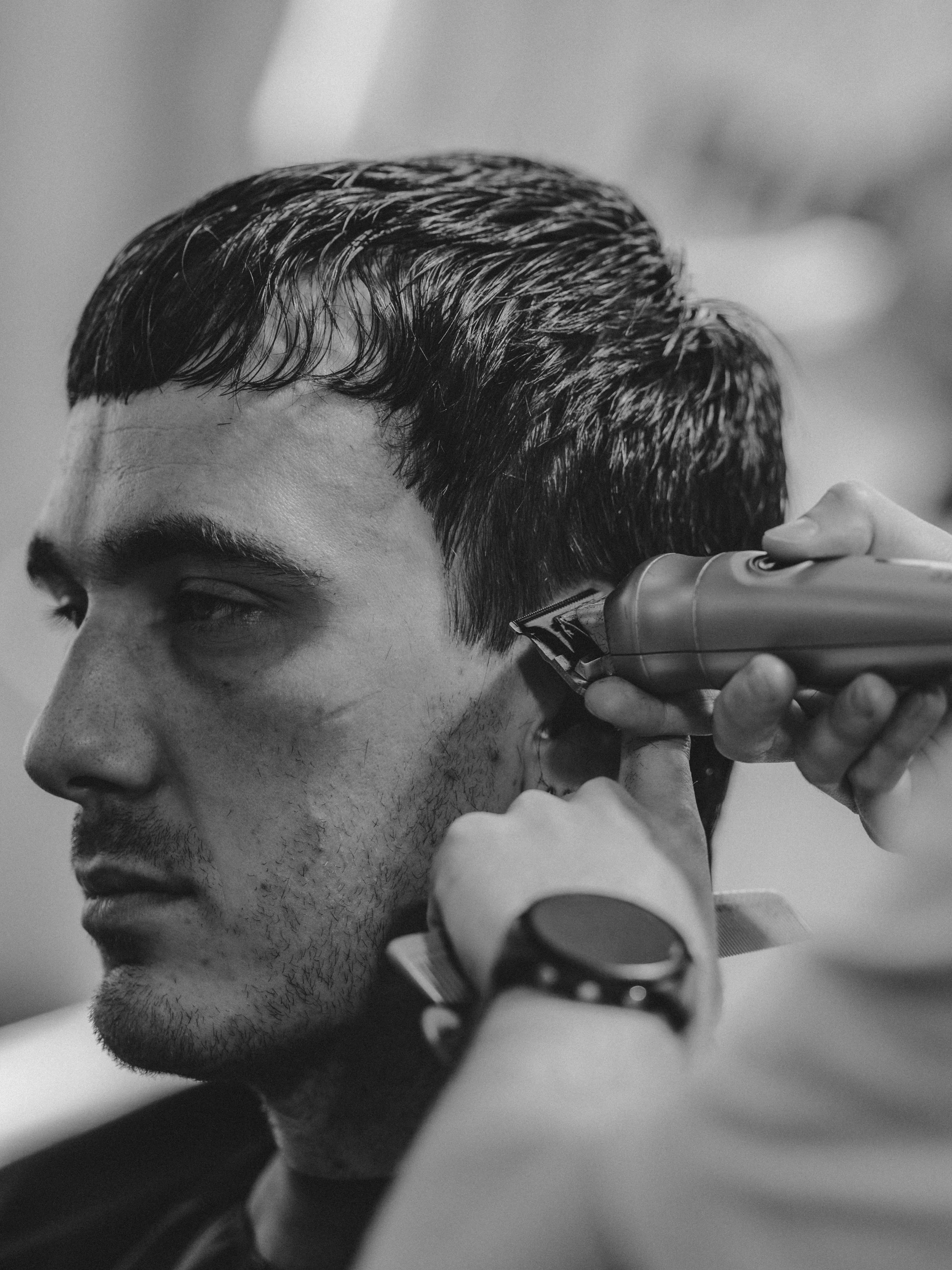 Black and white of man getting a haircut with razor