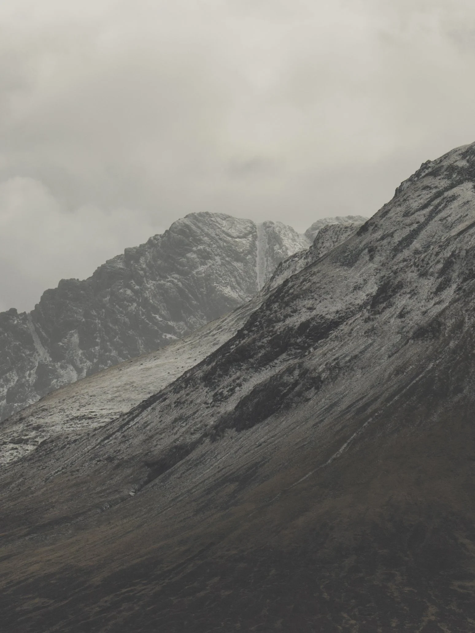 Scottish highland moody mountain with dusting of snow