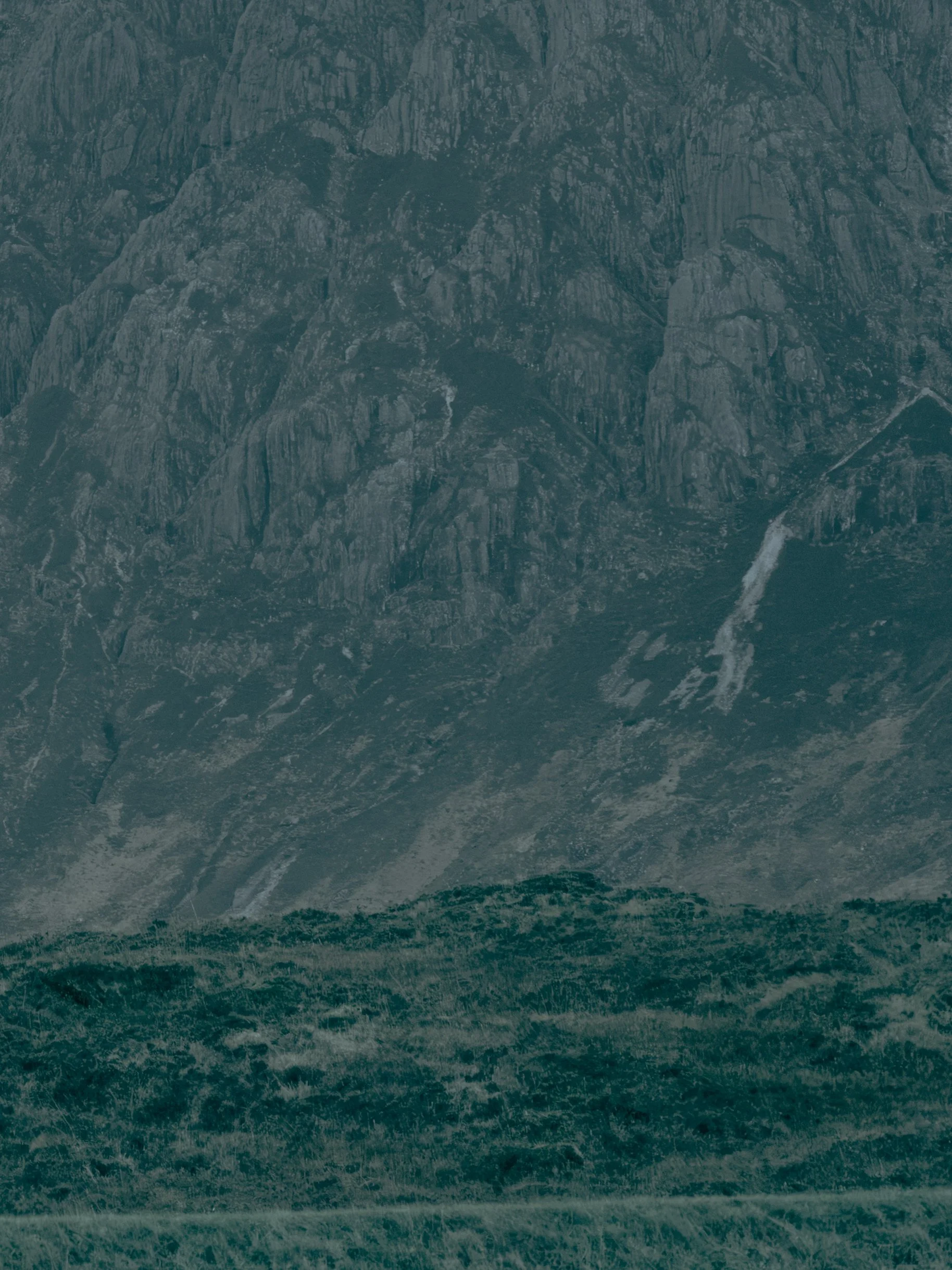 A mountain with a river running through the valley.
