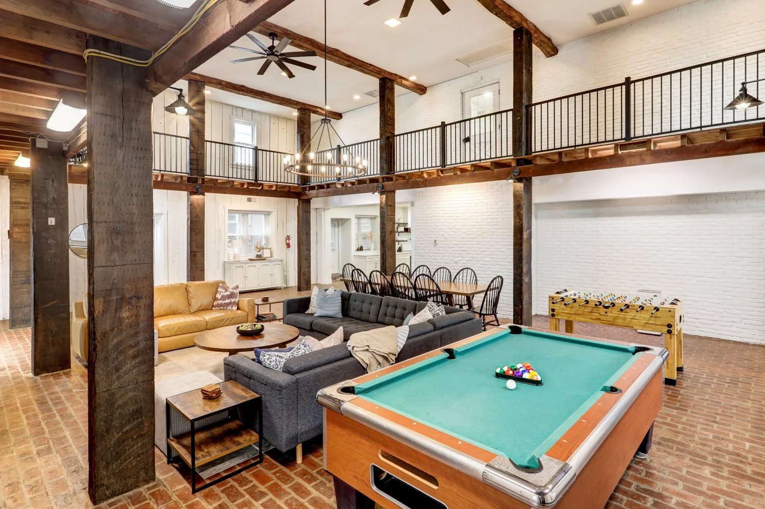 Game room area with pool table, foosball table, dart board, putterball game, Infinity game table, and record player. 
