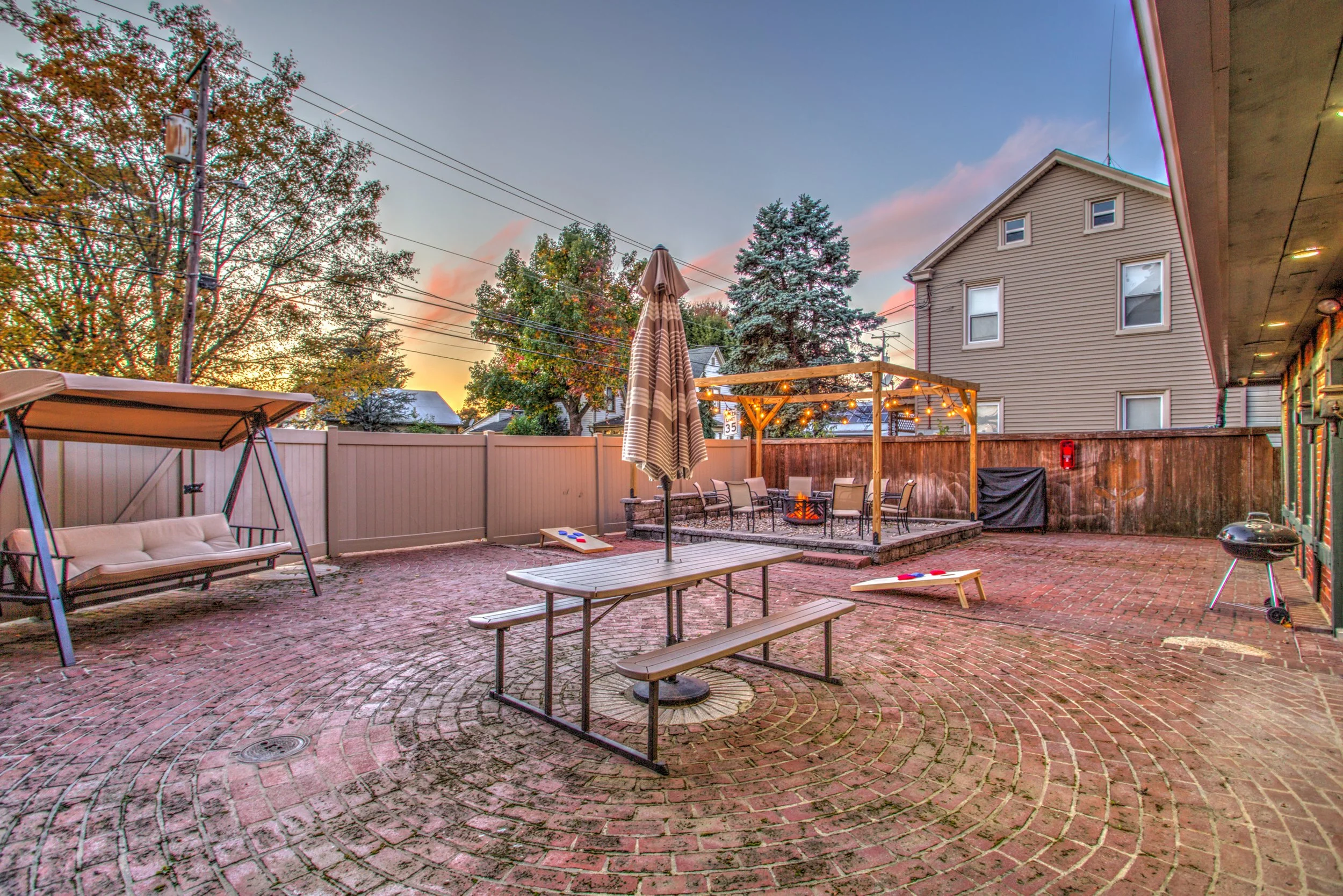 Private access to brick courtyard, with wood pellet grill/smoker, fire pit, and charcoal grill. Firewood, wood pellets, charcoal, and grilling supplies are provided. 