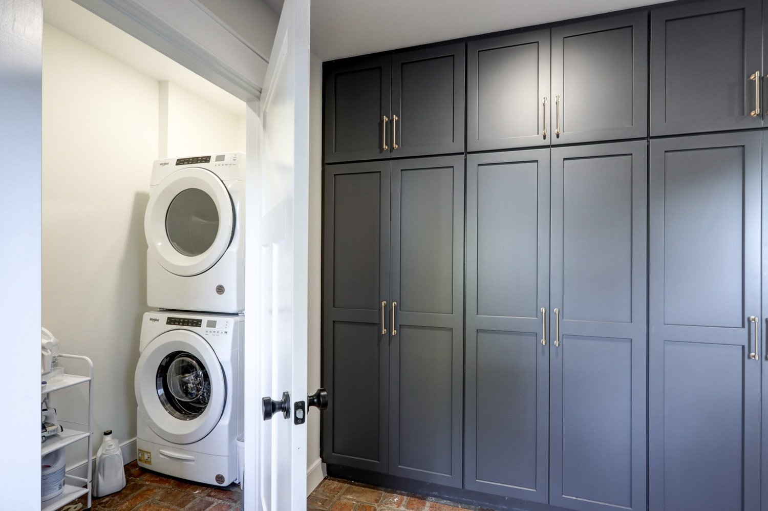 Laundry closet and pantry area. Waffle maker, panini press, air fryer, and electric griddle are stored in the pantry. 