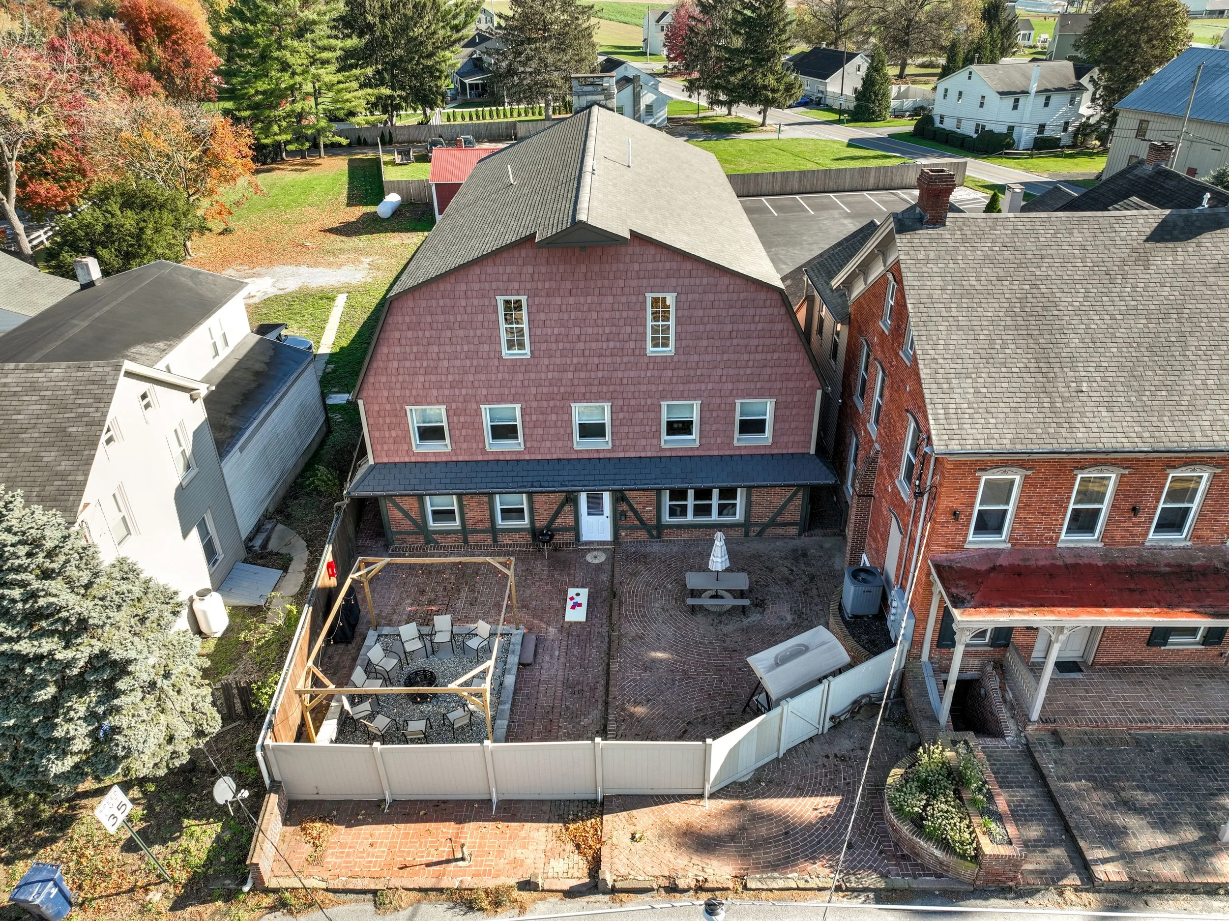 Brick courtyard with wood pellet grill/smoker, fire pit, and charcoal grill. Firewood, wood pellets, charcoal, and grilling supplies are provided. 
