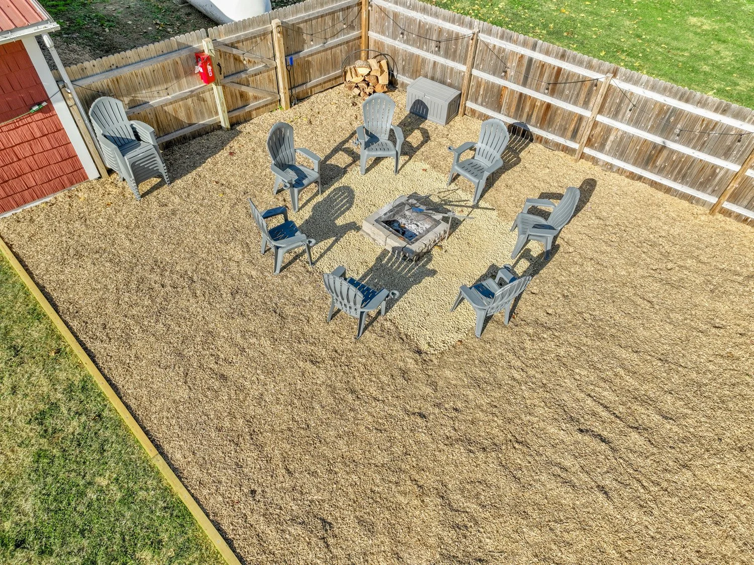 A large fire pit with a grilling grate and a charcoal/propane grill is in this area.  Charcoal, propane, firewood, and grilling supplies are provided. 