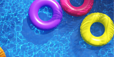 Colorful inflatable pool rings floating on a swimming pool.